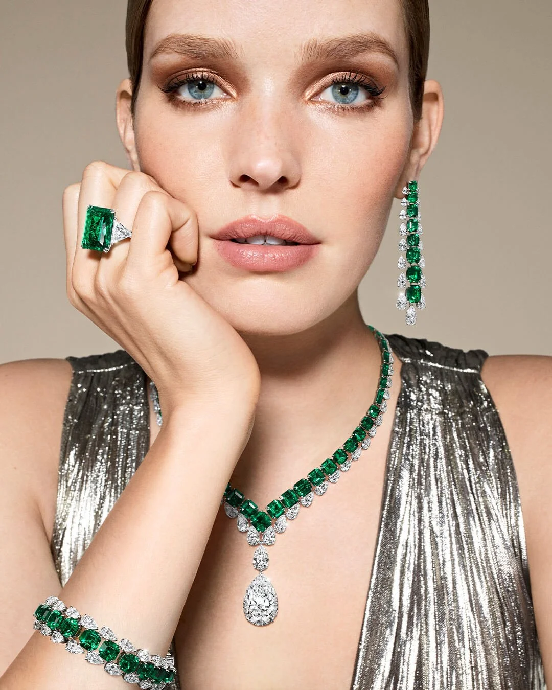 Close-up-of-a-woman-wearing-Graff-emerald-and-white-diamond-high-jewellery.jpg