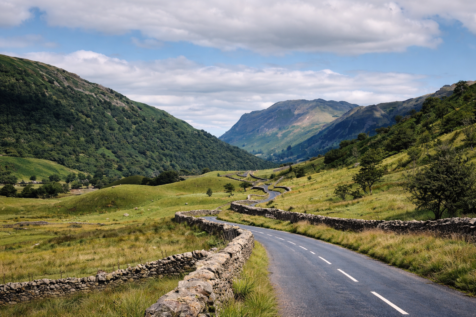 Winding road through Lake District valley.png