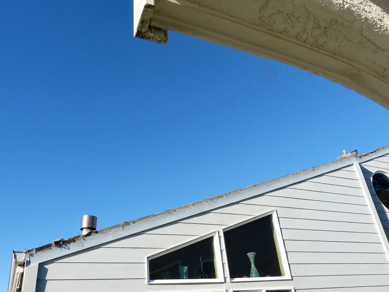 Birds nesting under the tiles at the bottom left corner,