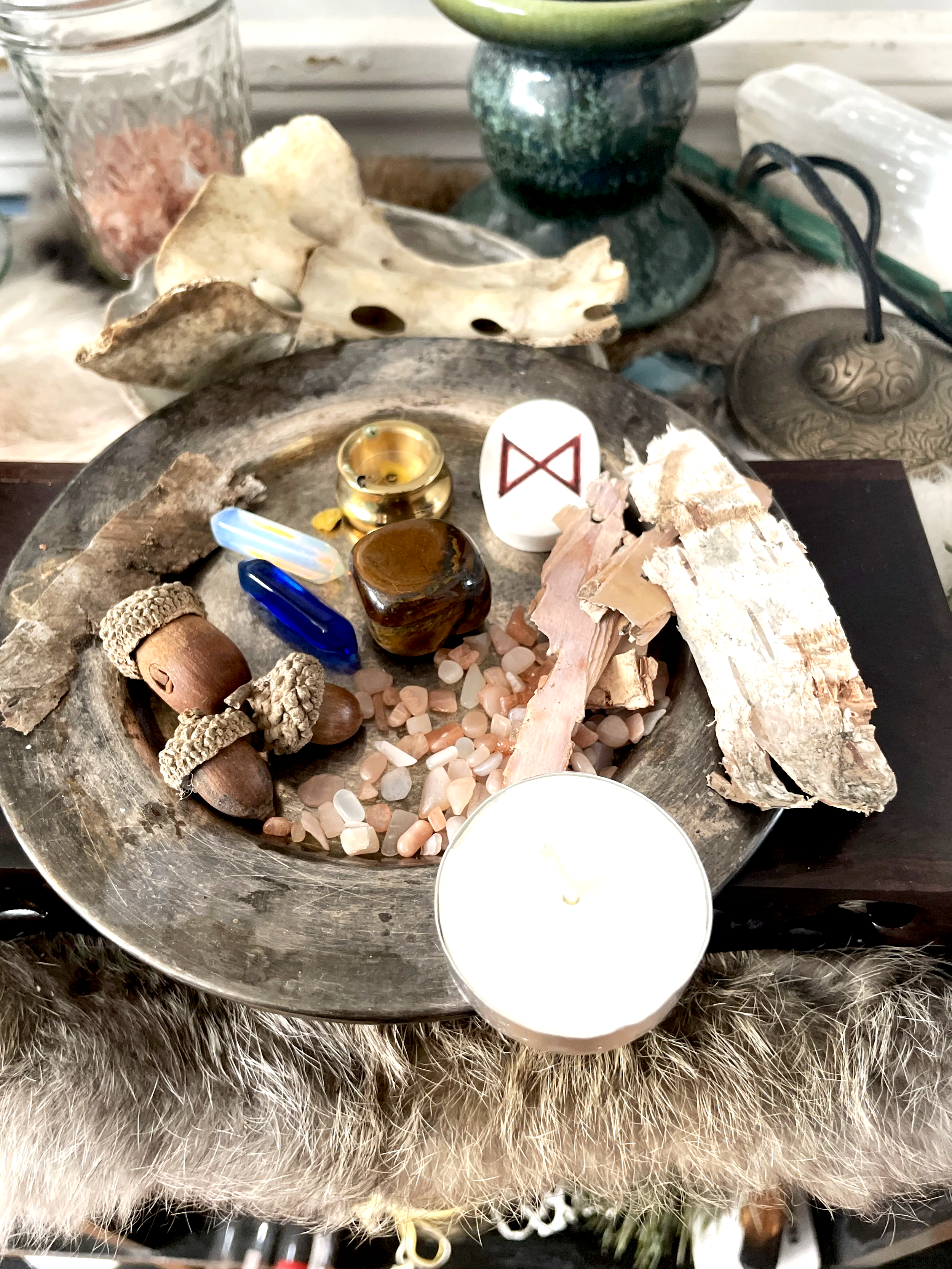 acorns, birch bark, crystals, rune and candle