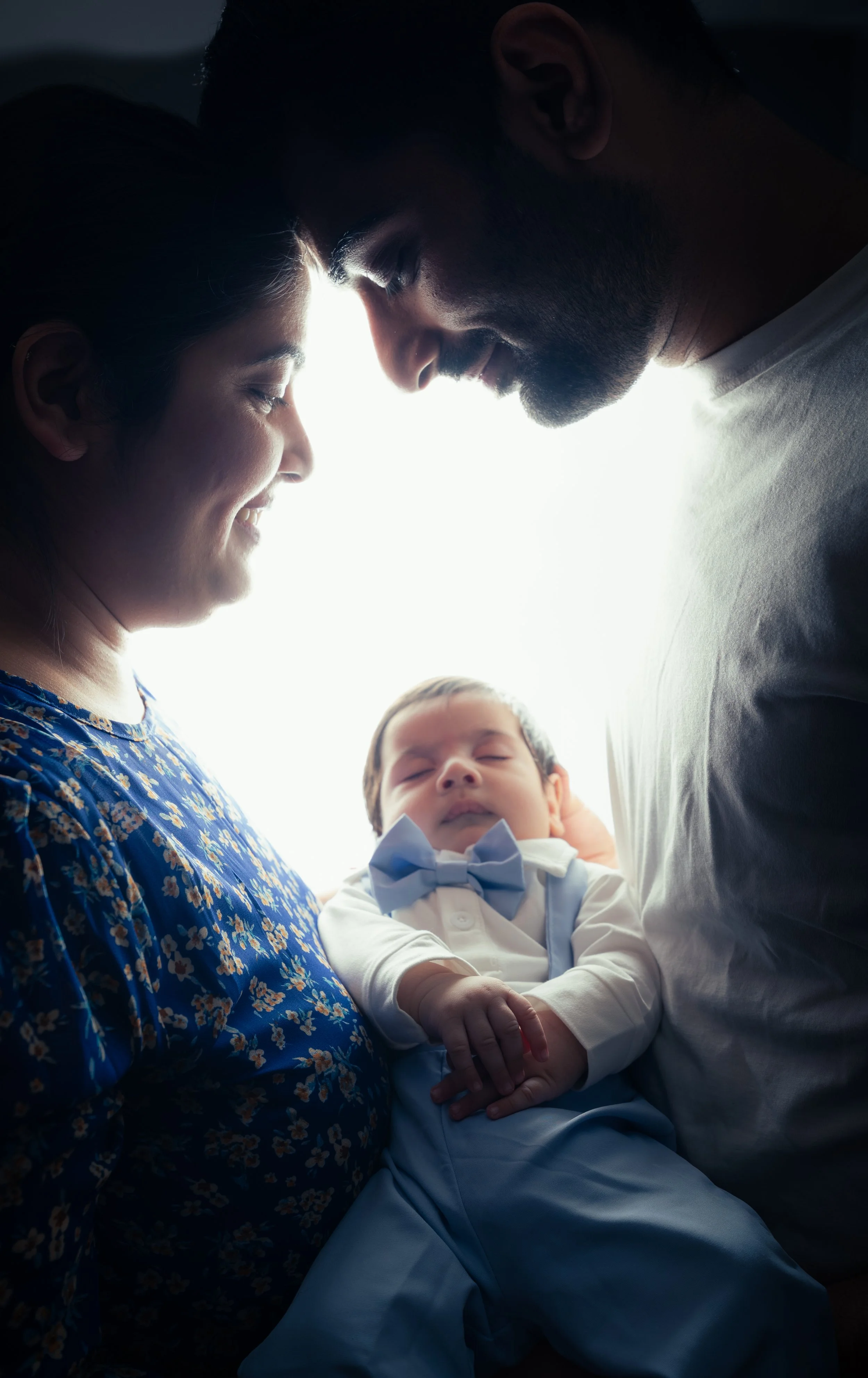 Beautiful backlit portrait of mother holding sleeping newborn baby | Newborn Photography Kitchener Ontario by Abhijeet Bhullar
