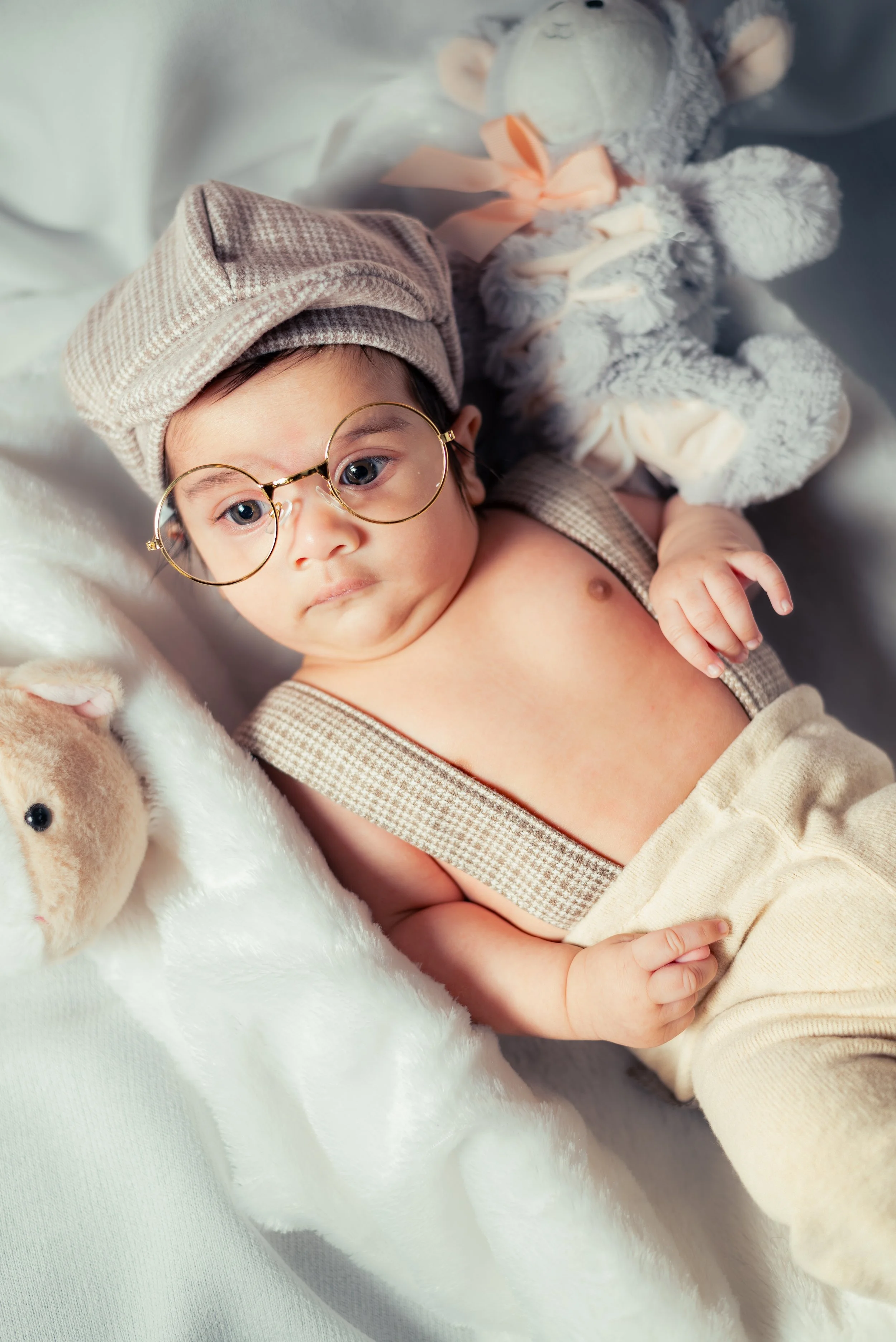 Cute newborn baby with round glasses and flat cap | Newborn Photography Kitchener Ontario by Abhijeet Bhullar