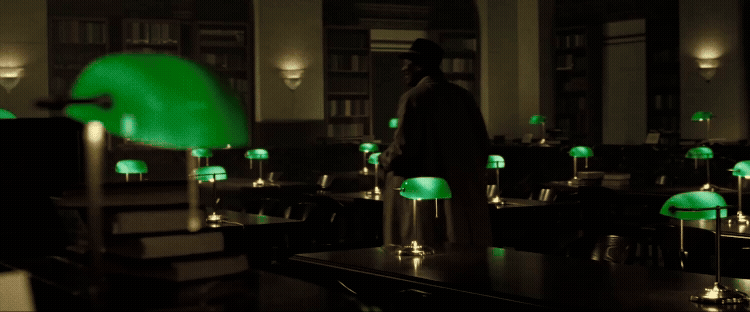 Scene from Se7en of man walking through stately library