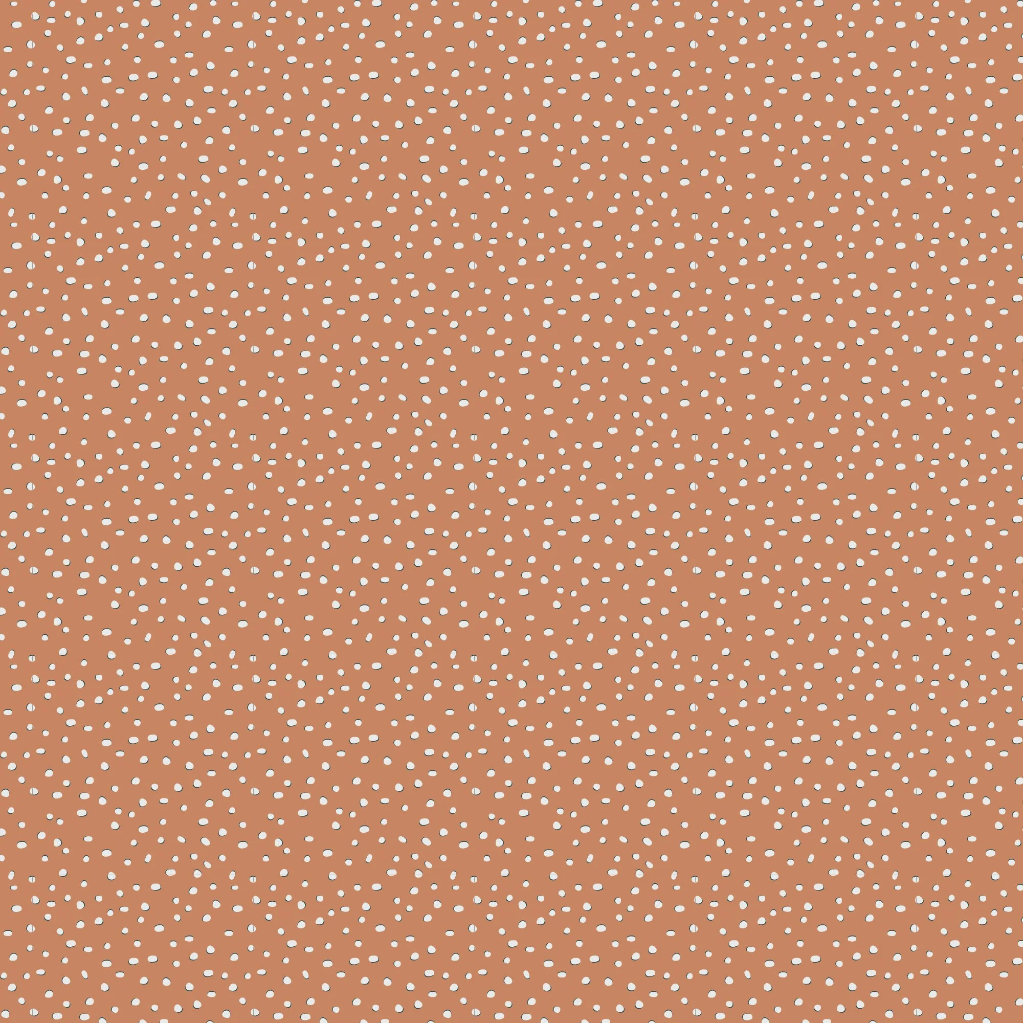 Close-up of an orange spice surface covered in small white specks that resemble snow or paint splatters.