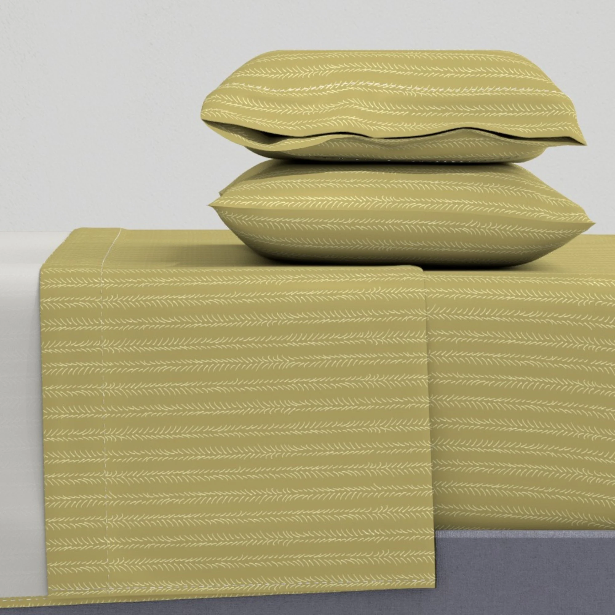 Two pillows and sheet set, in mustard yellow, with a light chevron stripe pattern, shown on a white bed mattress.