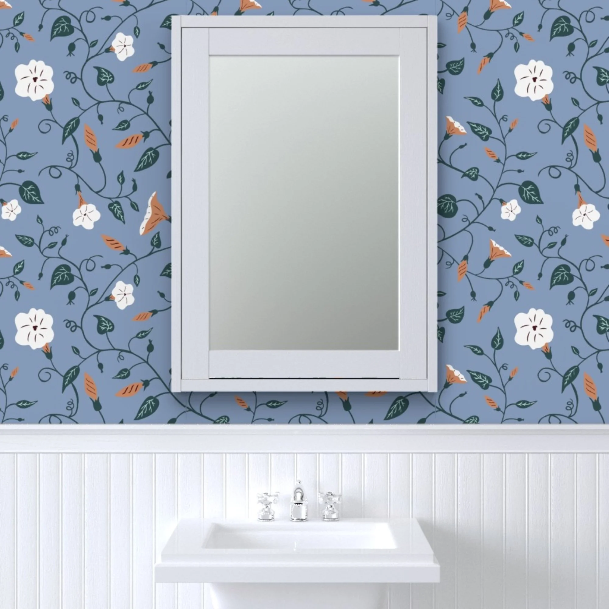A white bathroom sink with three faucets is set against a wall with blue floral wallpaper.