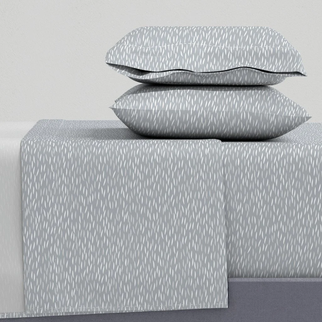 Bed sheet and pillowcase set in a small scale horizontal grain patterned fabric. in soft cream and gray tones.