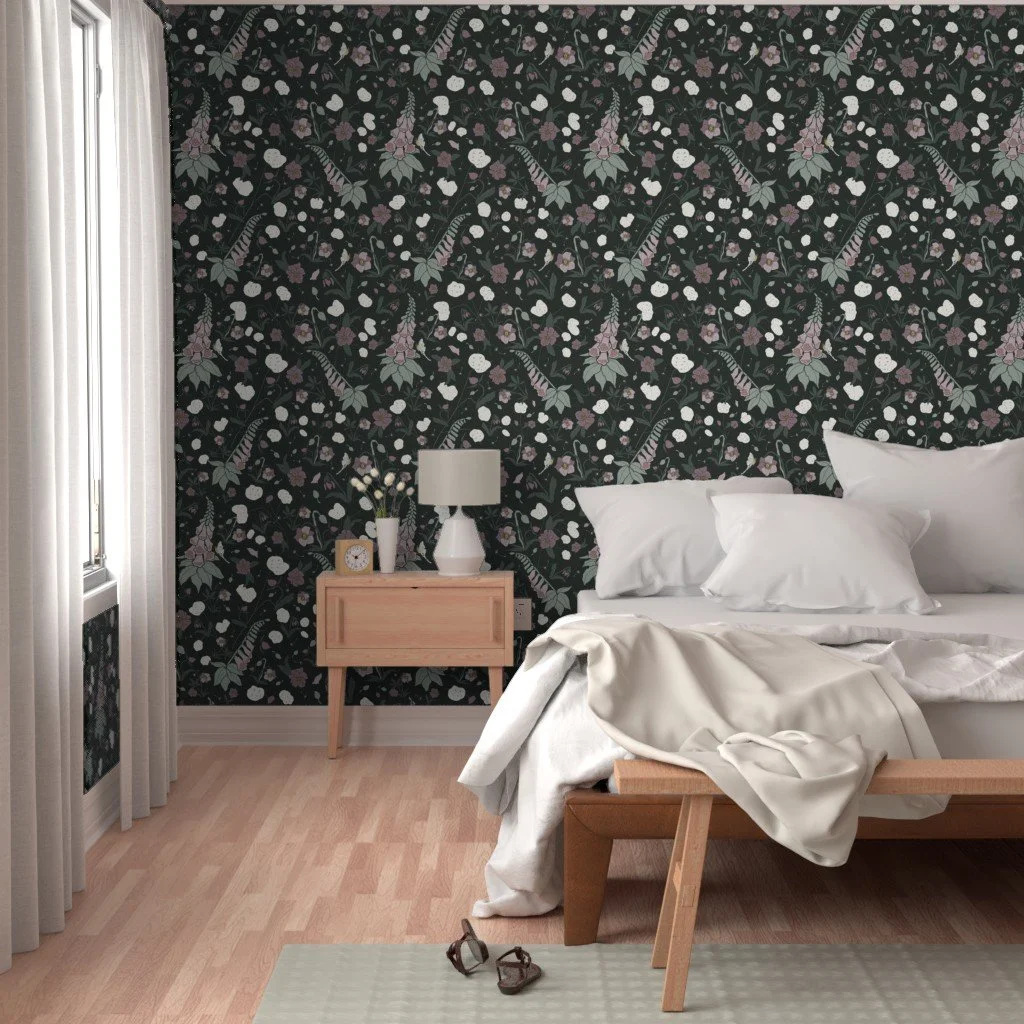 A bedroom with a dark green floral wallpaper behind the bed, a wooden nightstand with a white lamp, a bed with white bedding and pillows, and light-colored curtains next to a window.