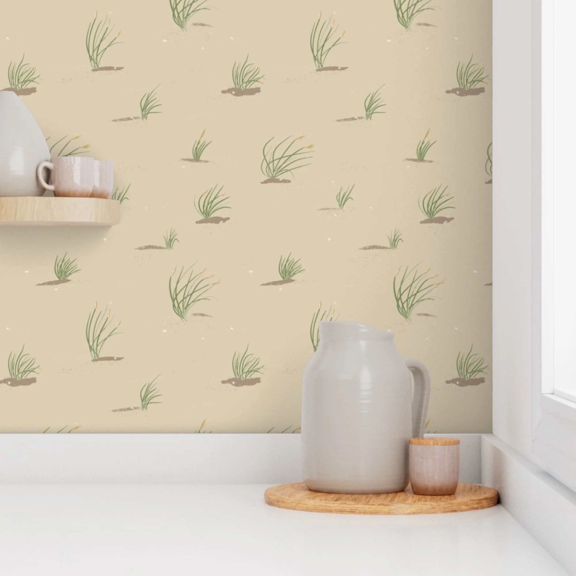 Interior of a room with a sandy beige wallpaper featuring a green beachy dune grass pattern, a wooden shelf holding two pink vases, and a white jar on a wooden tray on a white surface.