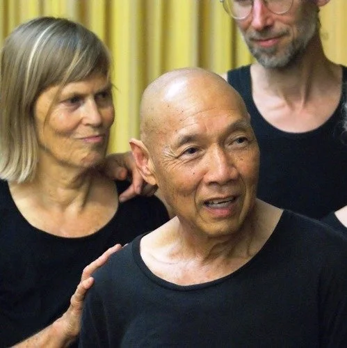 Three playback actors performing in black clothing.