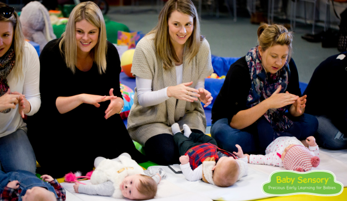 Four mums and their babies happily participating in a Baby Sensory class.