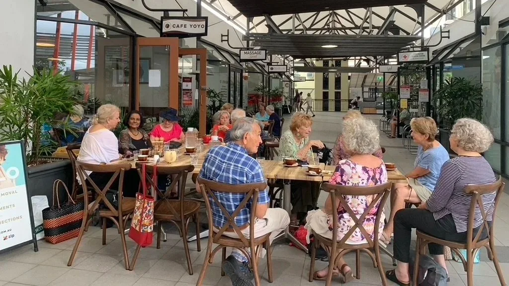 A group of seniors enjoying coffee and conversation at a local cafe.
