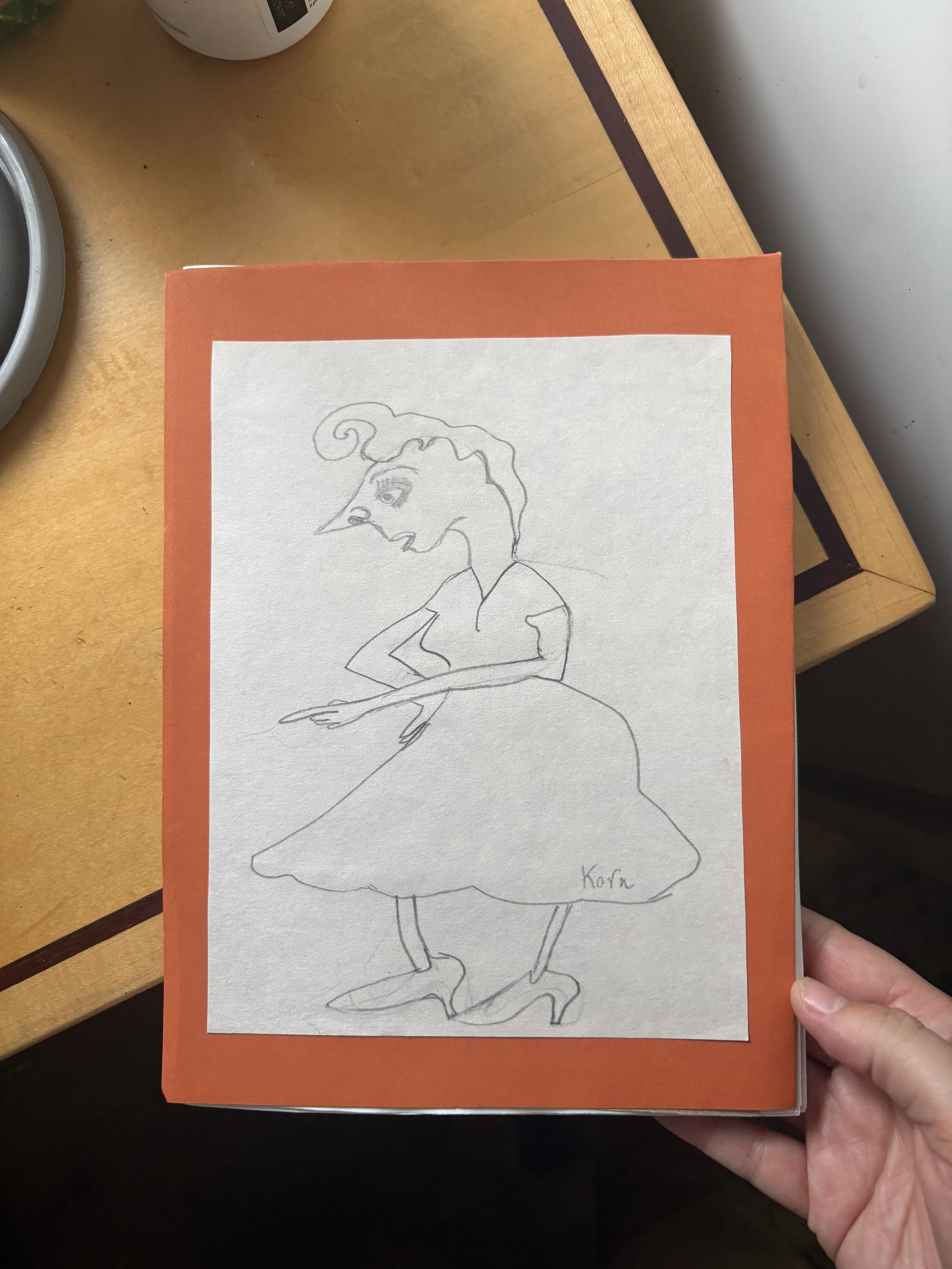 Line drawing of a woman with curly hair wearing a dress and high heels, with one arm crossed, signed 'Kora' in the bottom right corner.