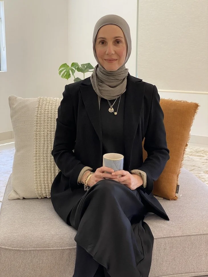 Sydney-based women’s health nutritionist seated with mug in holistic clinic setting at Matar Health