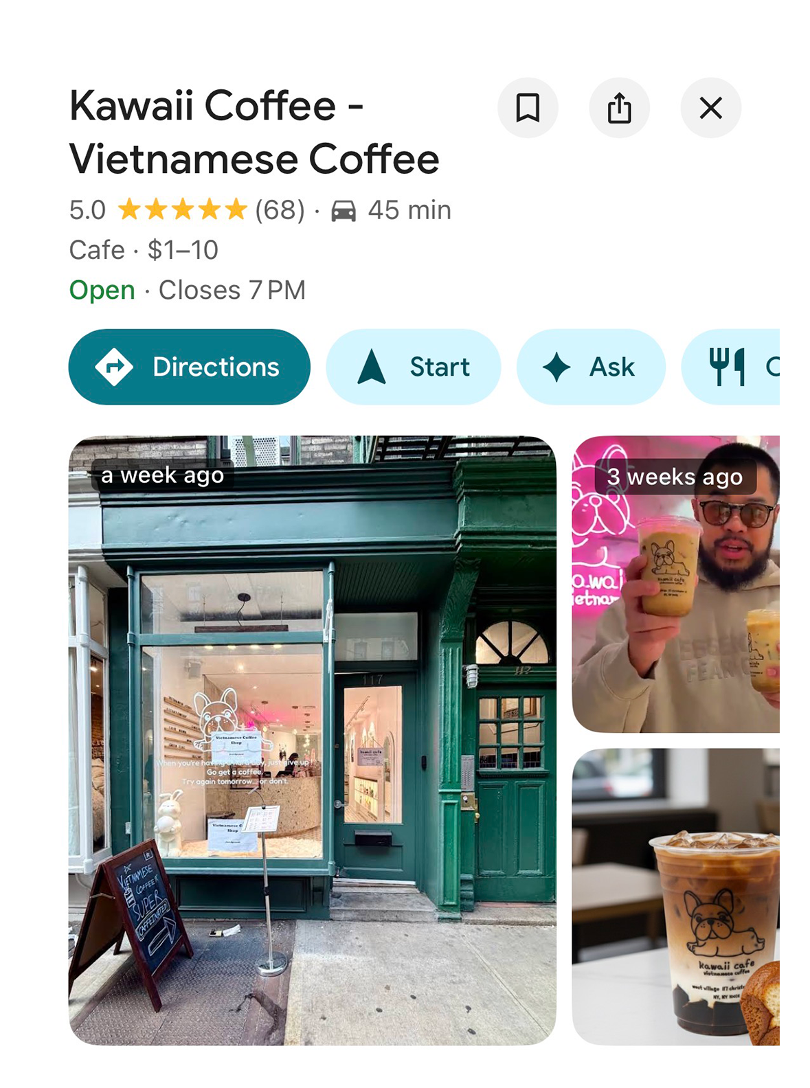 Exterior view of a green storefront called Kawaii Coffee - Vietnamese Coffee with a logo of a dog. There is a chalkboard sign outside and a small pole with a sign. The storefront features a large window with a dog logo and the text 'When you're happy, just give up! Go get a coffee. Try again tomorrow... or don't.' Inside the window, there is a rocking horse and other cafe decor.