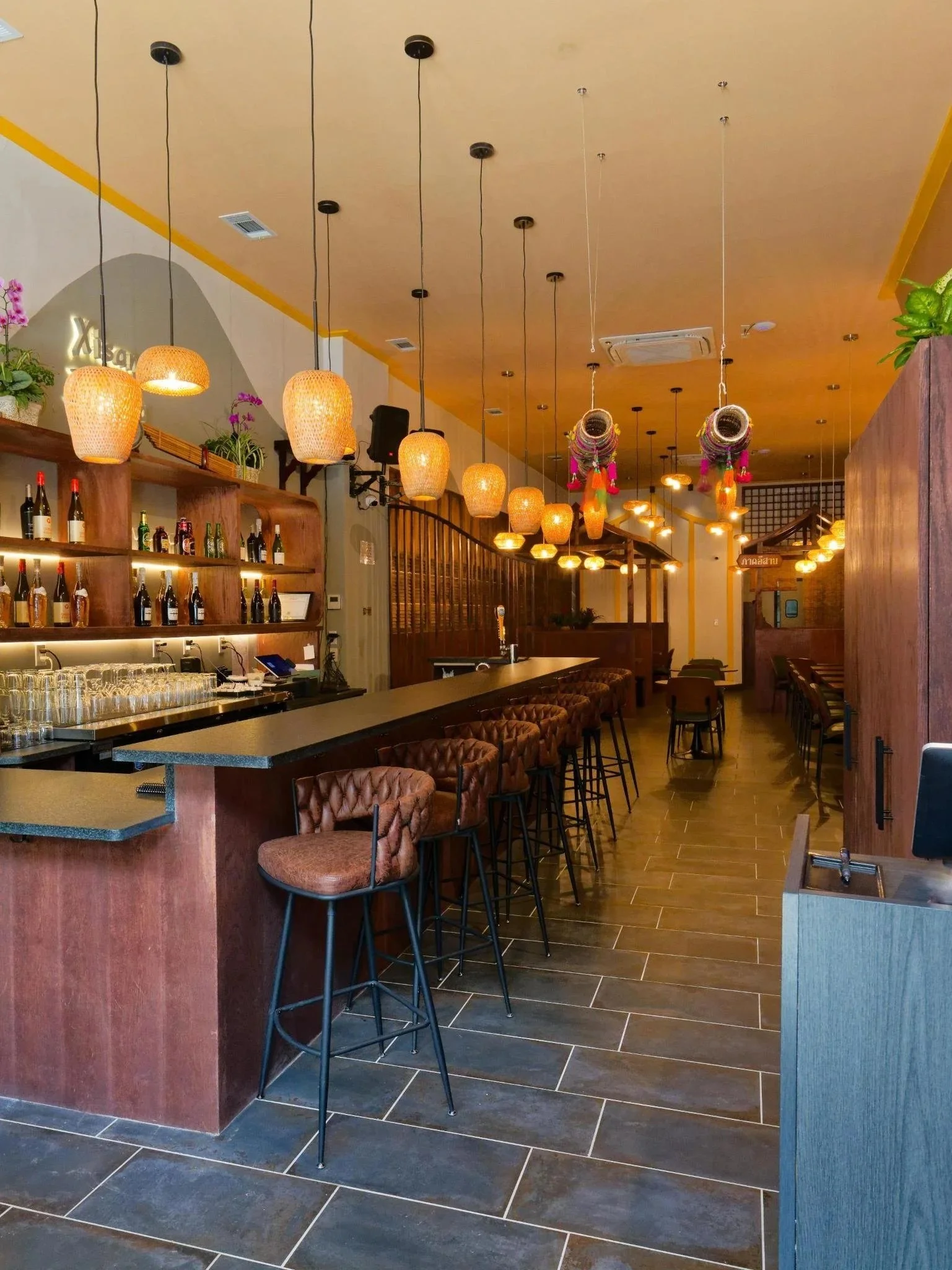 Modern Thai restaurant interior in Brooklyn Heights featuring custom bamboo ceiling installations and warm ambient lighting. Commercial renovation and interior design by XZ Design Build NYC.