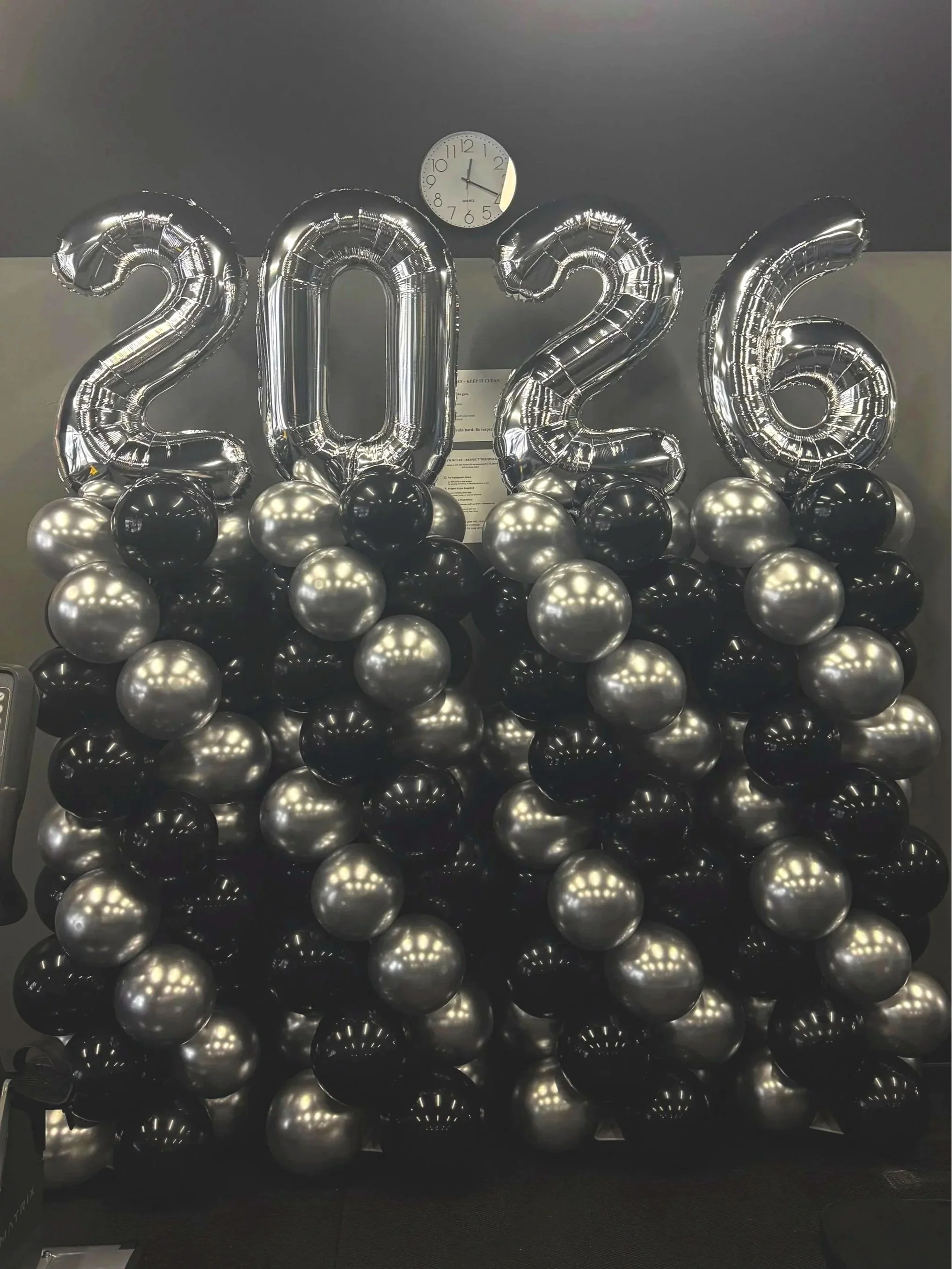 Black and silver balloon towers forming the numbers 2026.