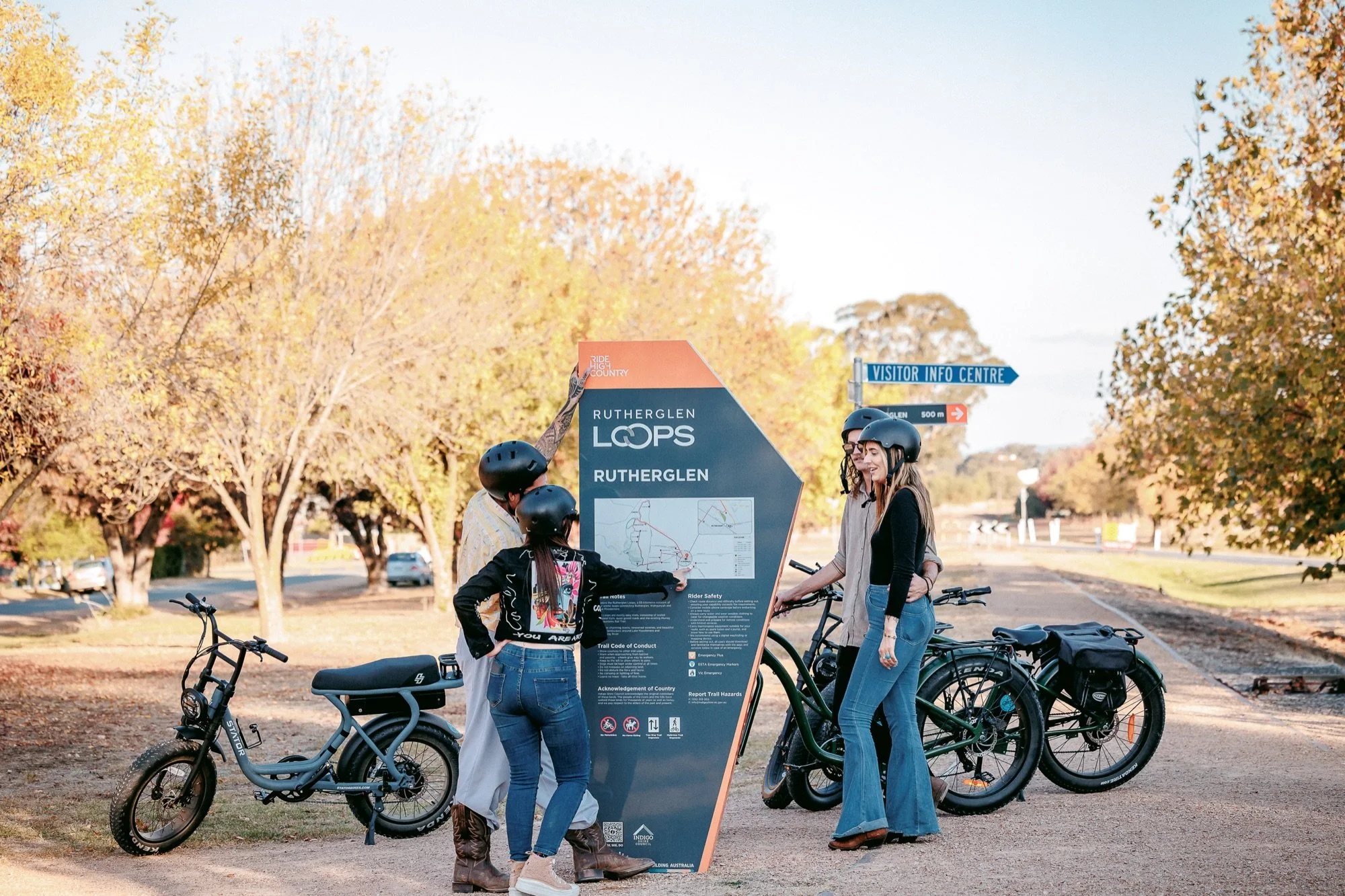 Cyclists with e-bikes at the Rutherglen Loops trail sign in Rutherglen