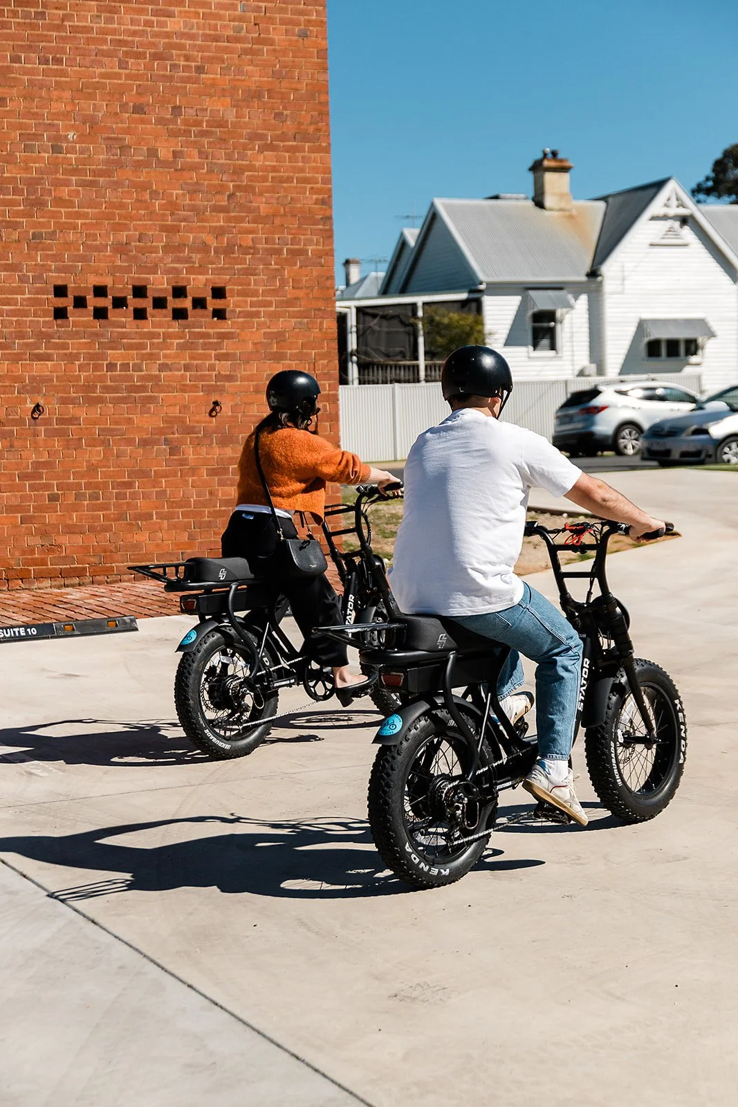 Two guests heading out on e-bikes from The Victoria Rutherglen's secure guest parking
