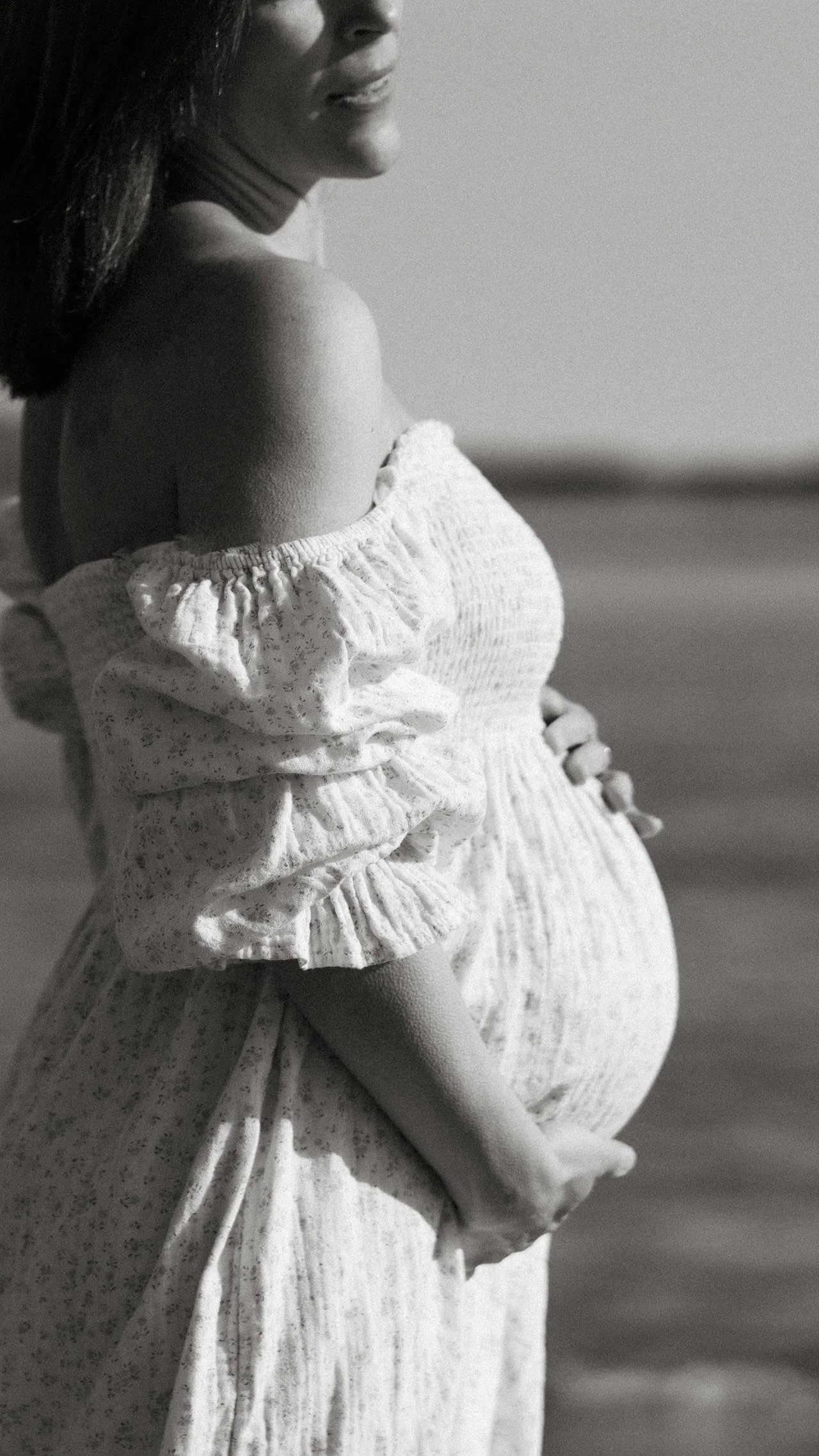 pregnant woman in a dress holding belly preparing for therapy for maternal mental health in chicago, illinois