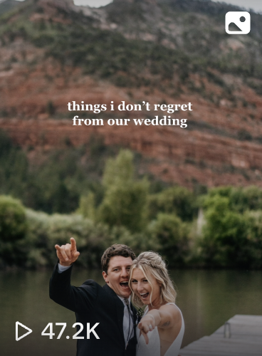 Happy couple at their wedding outdoors with a river and red rock cliffs in the background, smiling and pointing at the camera.