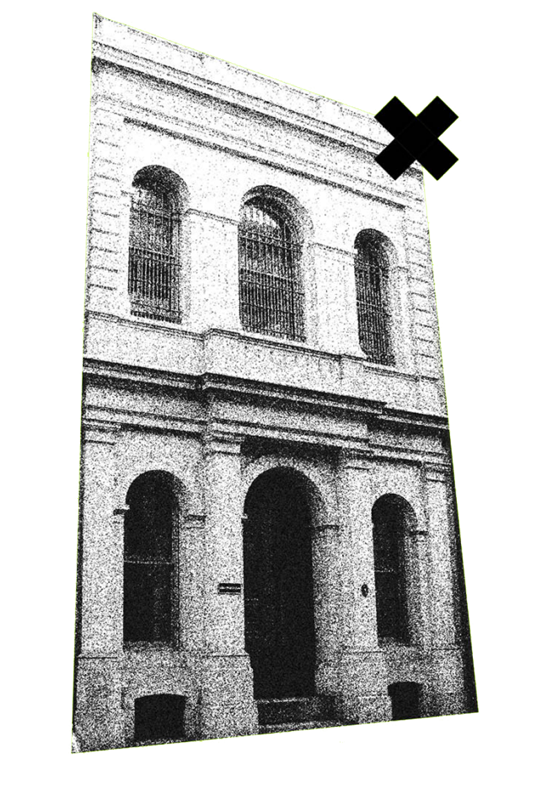 Black and white photo of an old brick building with arched windows and doorways, seen from a low angle, with some distortion and noise.