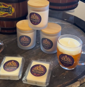 Assorted B.B. Butterbeer products including jars, blocks, and a glass of butterbeer on a display counter.