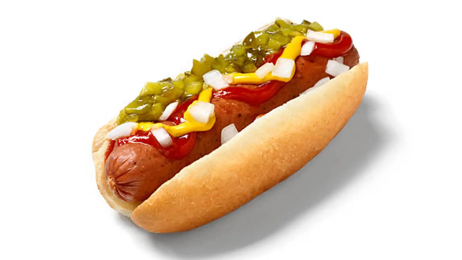 Hot dog with ketchup, mustard, chopped onions, sweet relish, and chopped pickles in a bun.