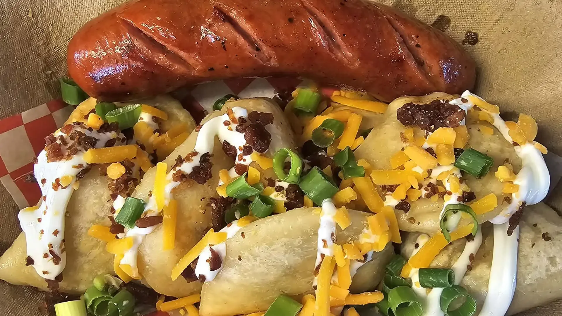Steak, dumplings topped with sour cream, shredded cheddar cheese, chopped green onions, and crumbled bacon.