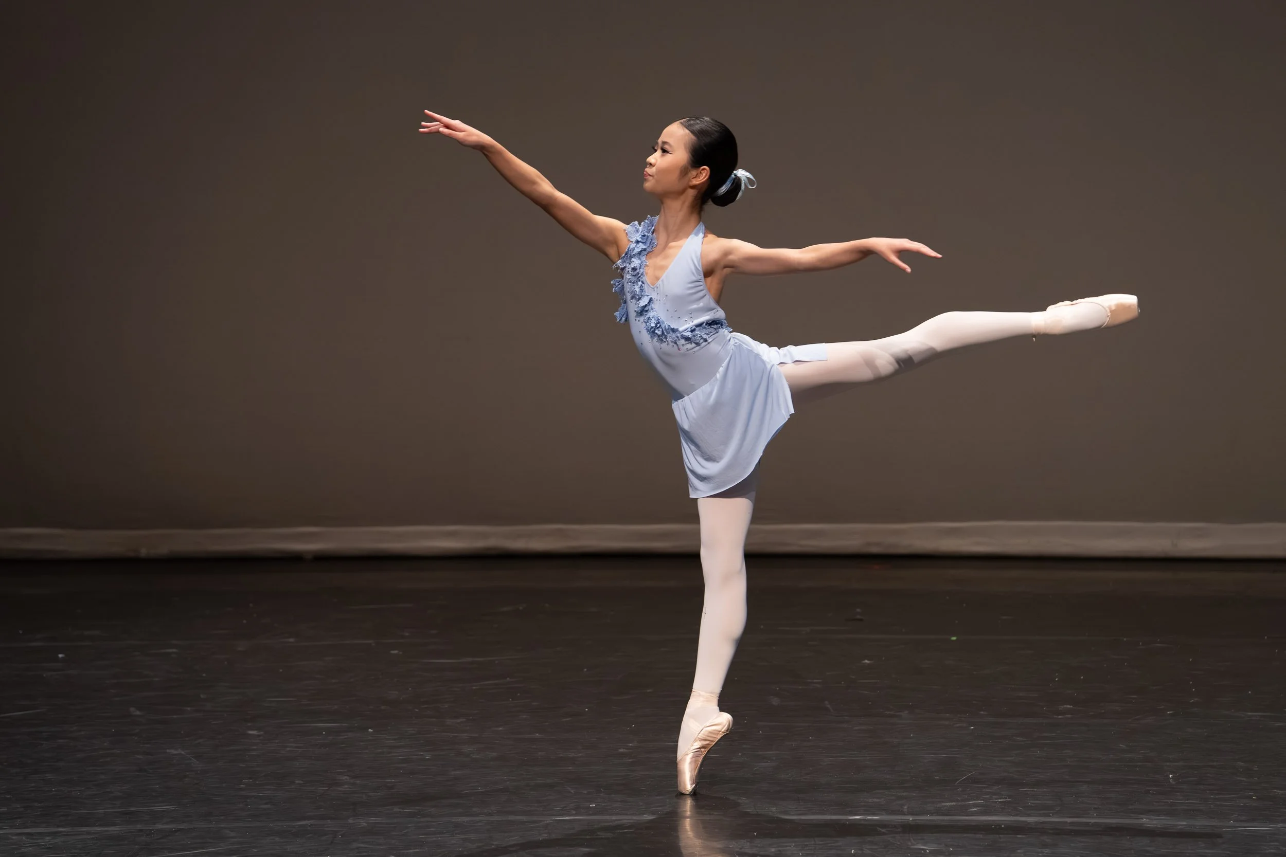 A dancer from Tri-City Dance Center performing a perfect technical extension during a pre-show rehearsal in Port Moody.