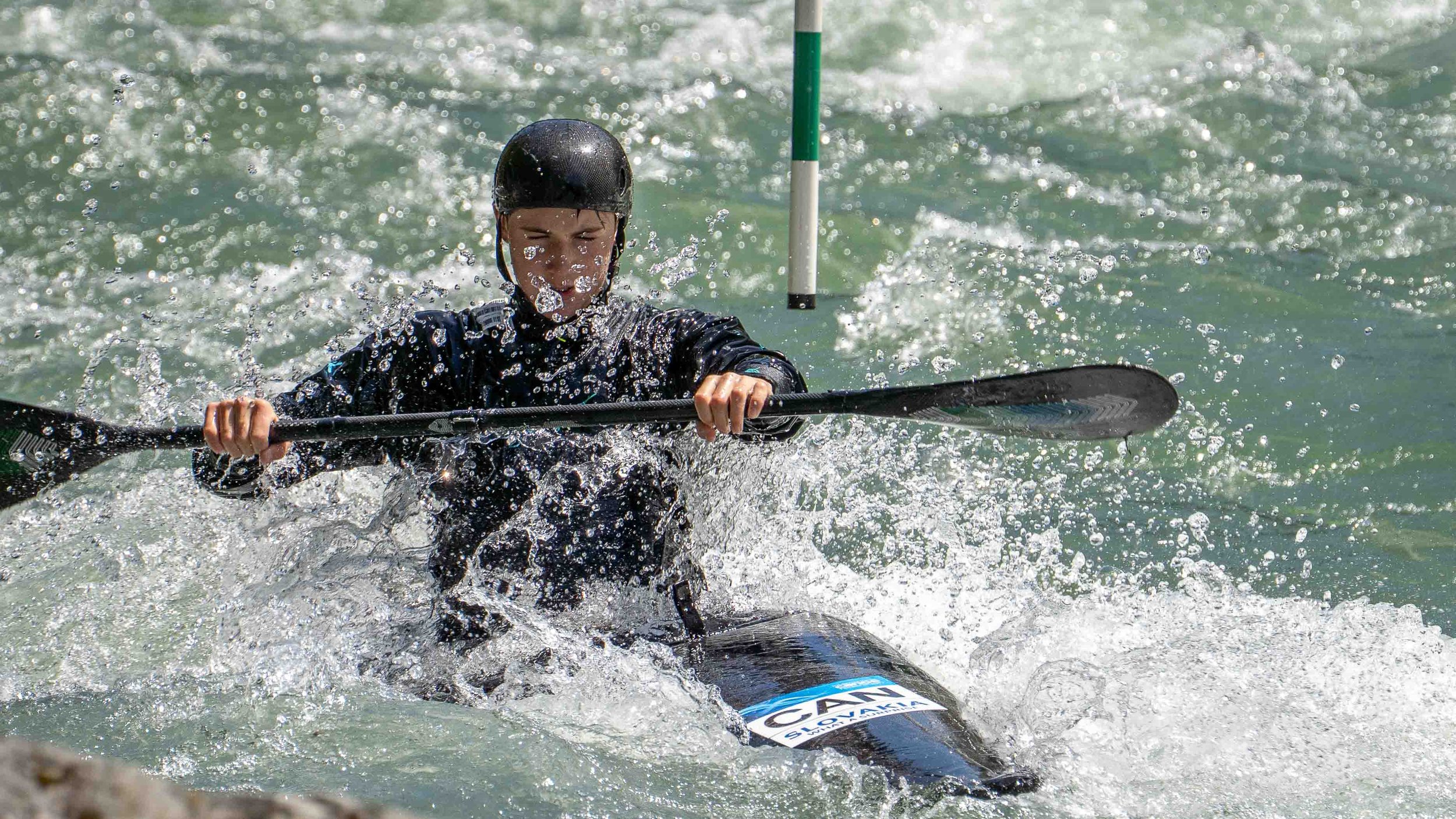 Action photography of Team Canada kayaker Alex Smineko training in Chilliwack for the World Championships. High-speed shutter capturing whitewater spray and elite athletic performance.