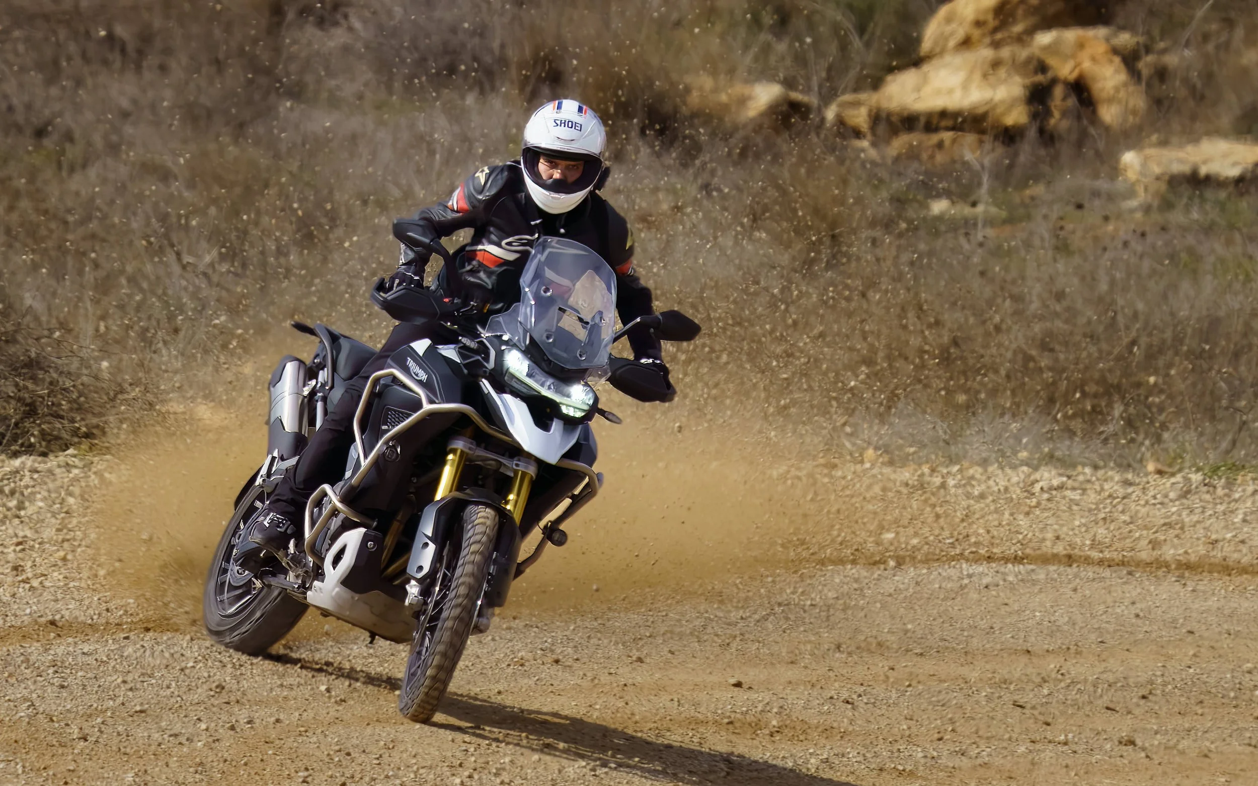 "Action shot of a Triumph Tiger adventure motorcycle off-roading captured by Peak Action Photography.