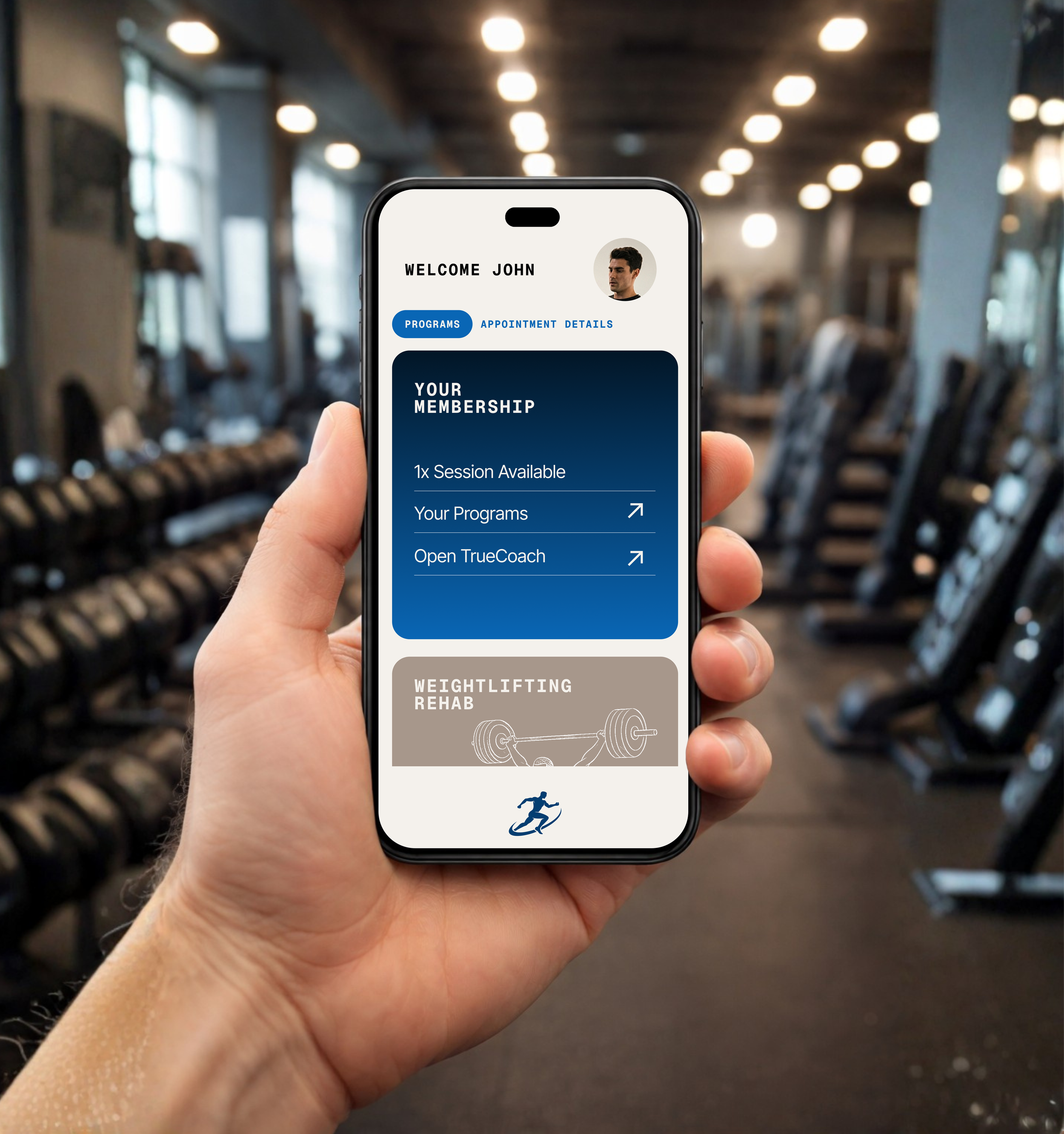 A person holding a smartphone in a gym, showing a fitness app screen with membership details and workout programs.