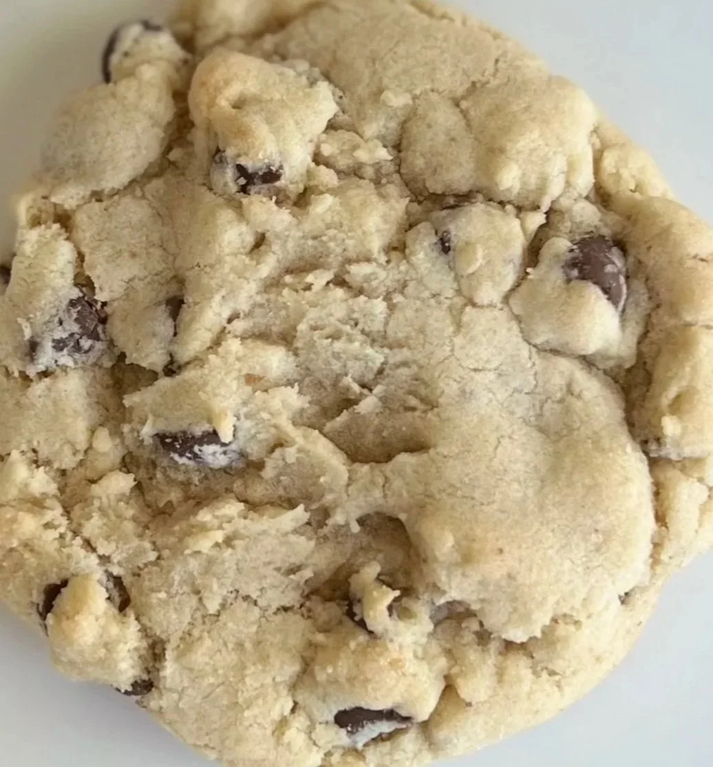 Close-up image of a chocolate chip cookie with a crumbly texture.