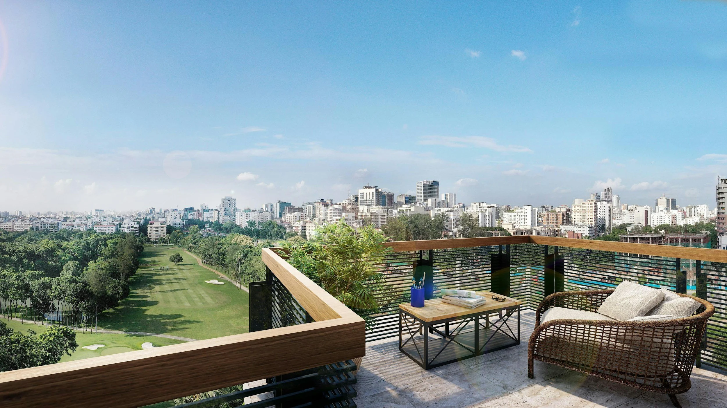 View from a balcony overlooking a city skyline with a park in the foreground, including trees and a golf course, under a blue sky.