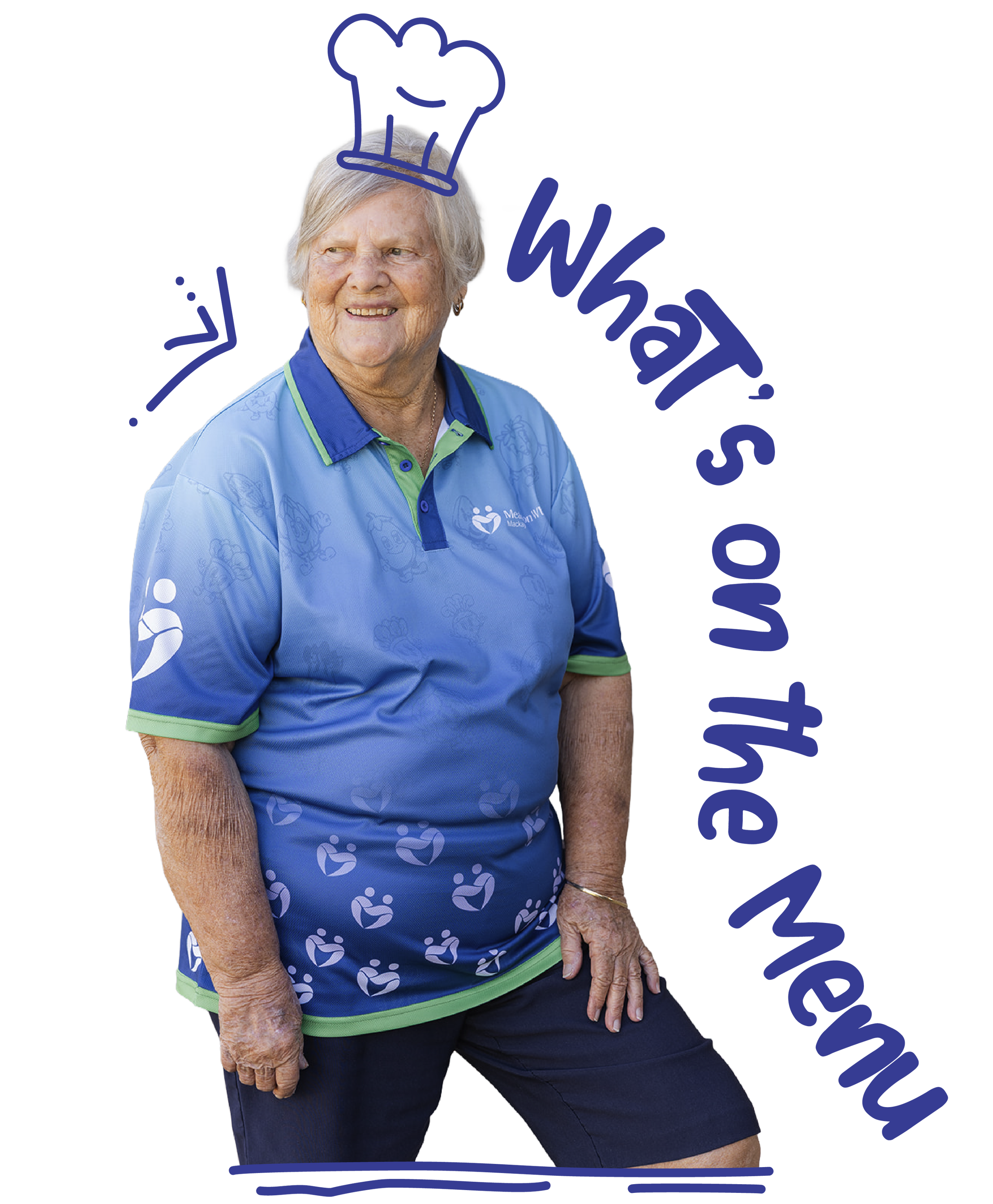 An elderly woman with gray hair smiling, wearing a blue shirt with a heart logo, and navy blue shorts, sitting with her legs crossed, against a plain background.