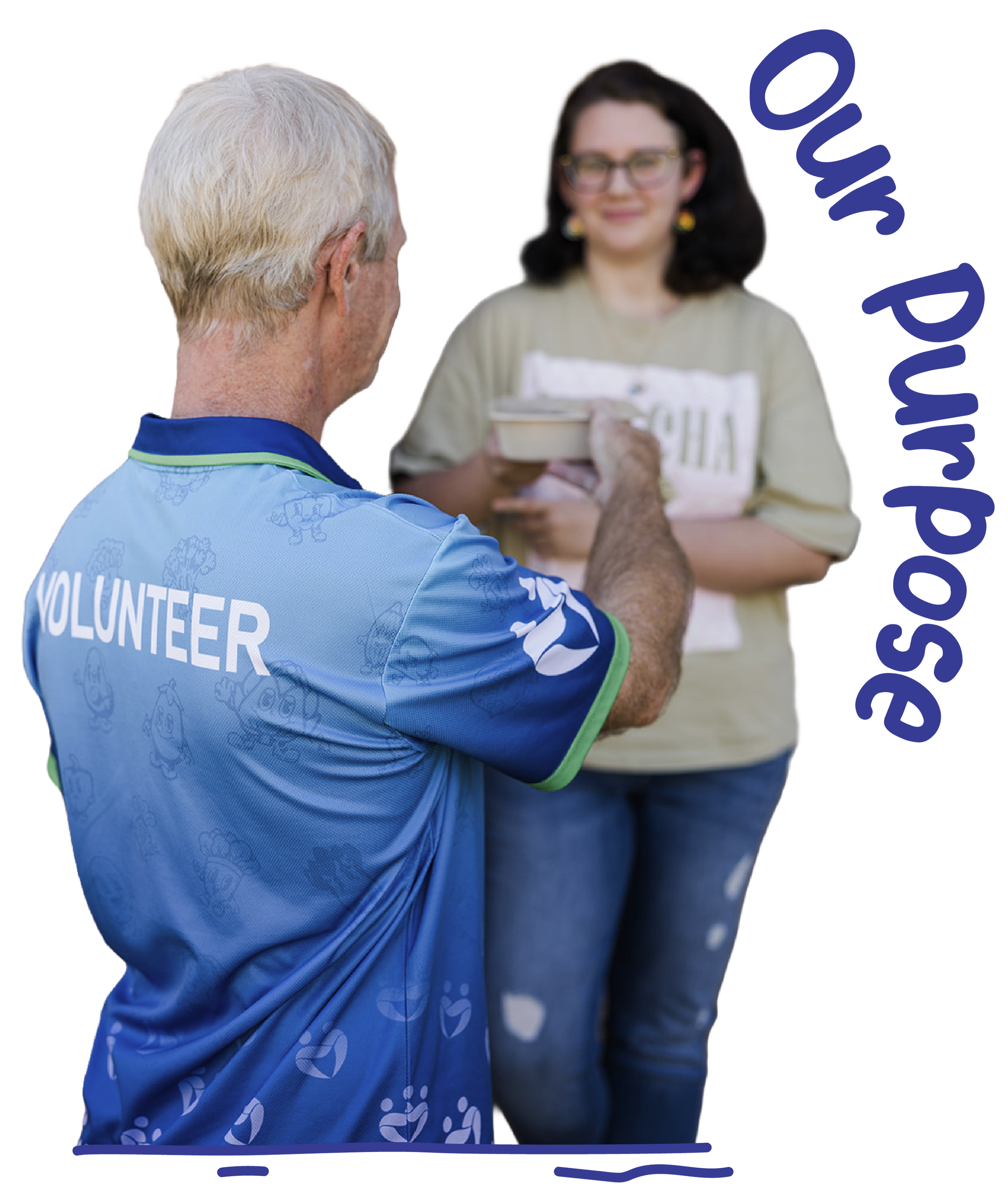 A man wearing a light blue shirt labeled 'Volunteer' on the back handing a small box to a woman with dark hair and glasses, who is smiling.
