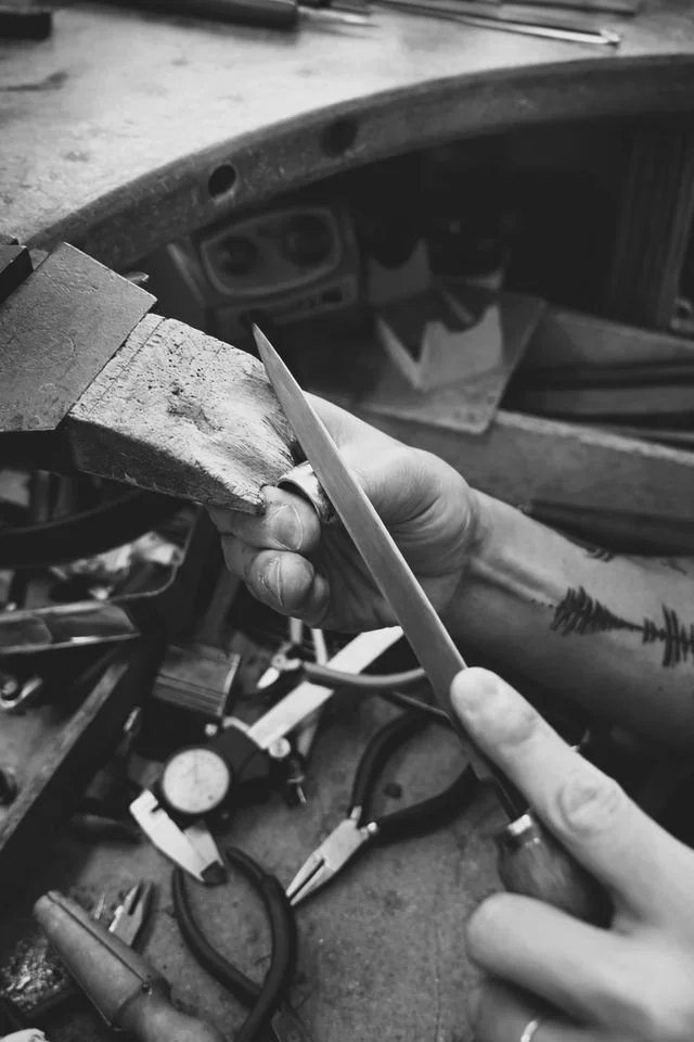 A jeweller working on remodelling a ring.