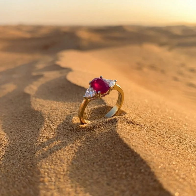 A gold ring with a ruby and diamonds.