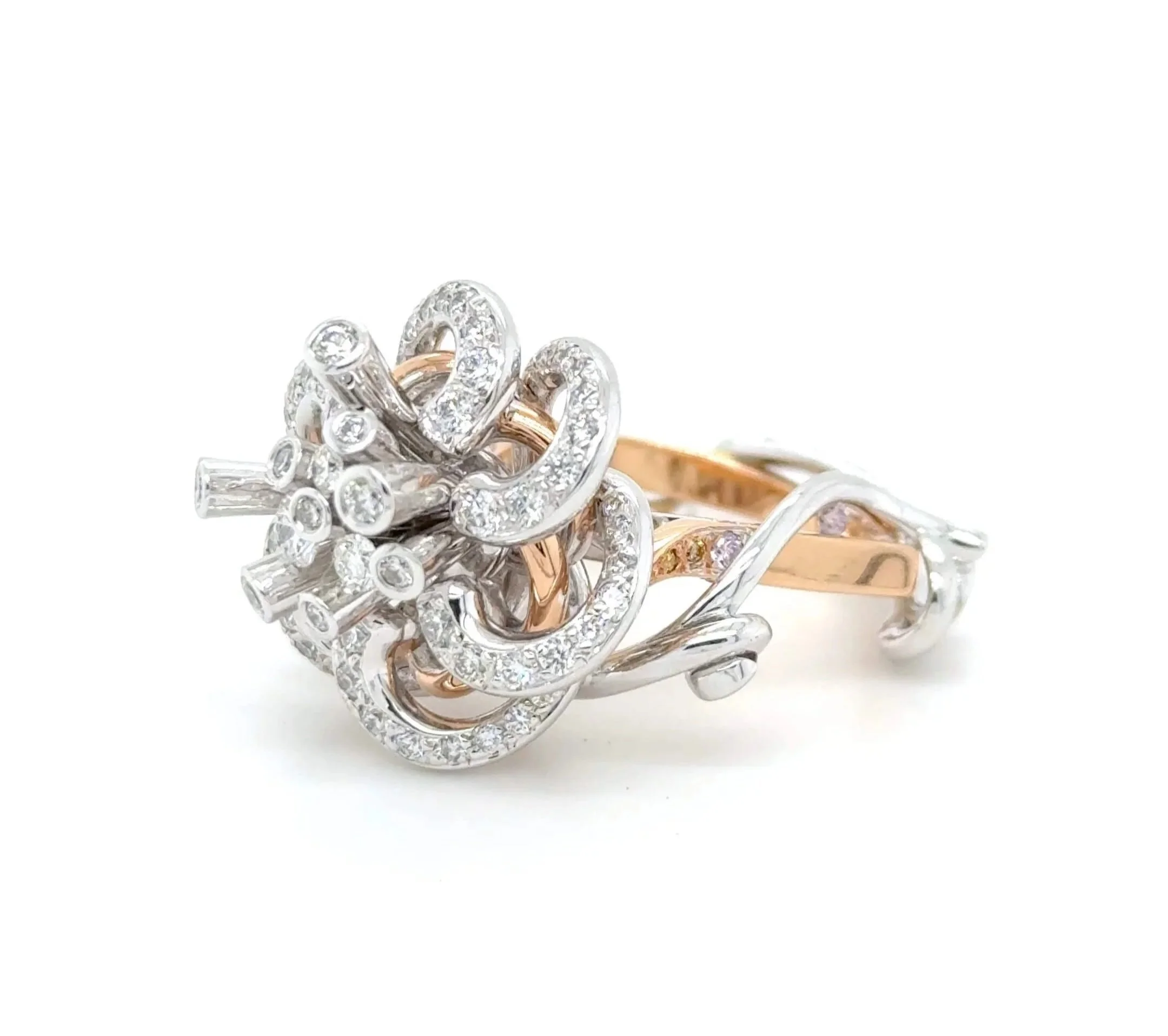 Sculptural white and rose gold ring with diamonds.