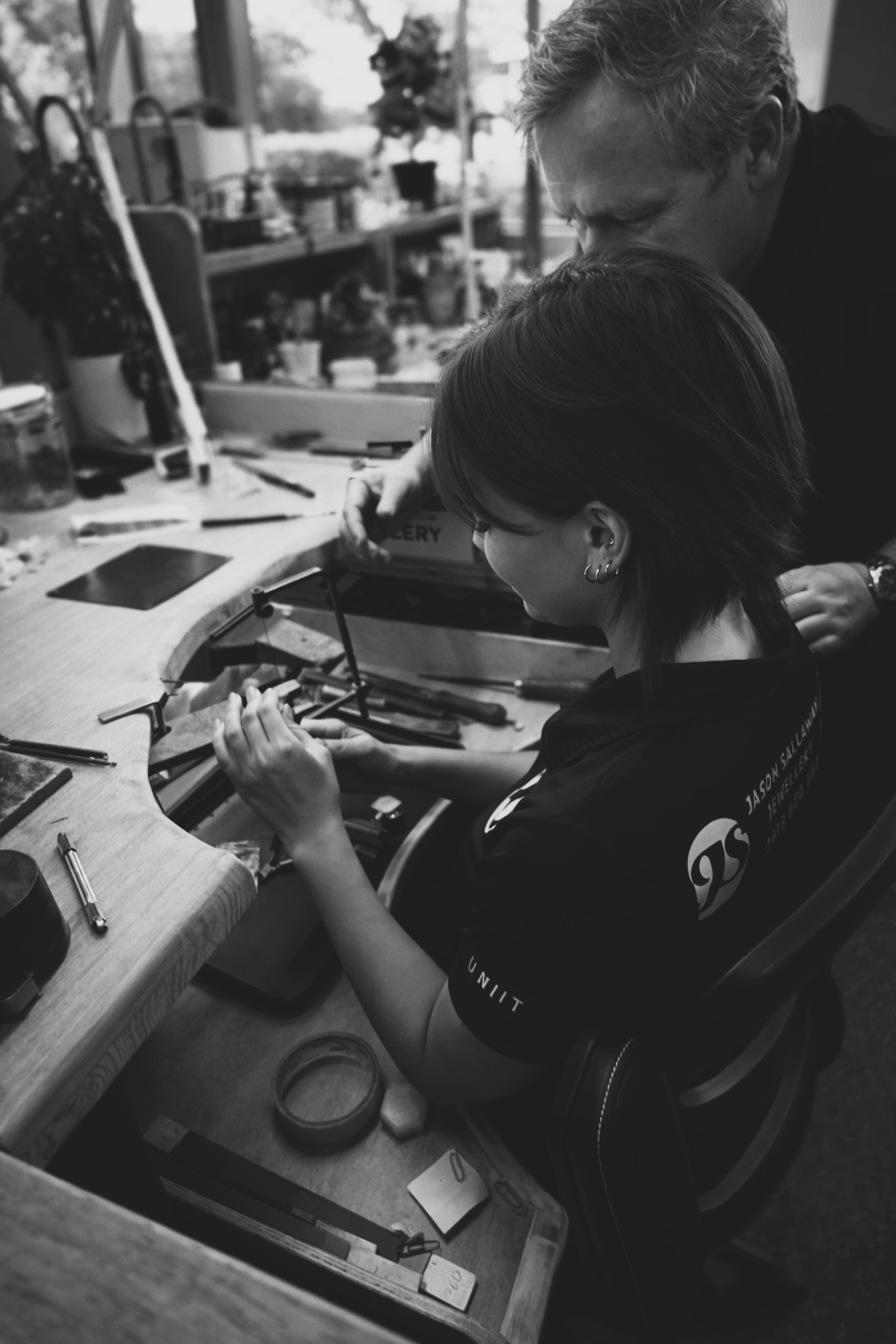 A jeweller using tools to craft a ring.