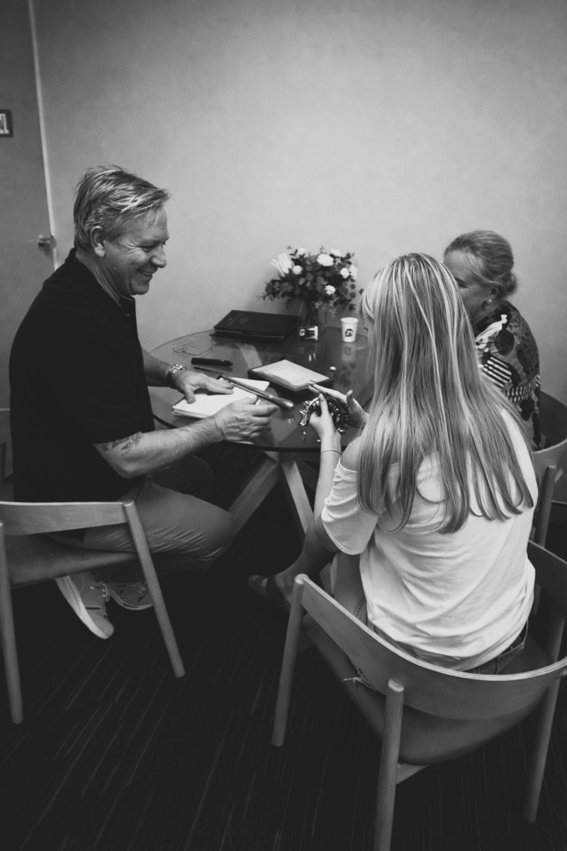 Jason and a customer discussing ring sizing for a custom design.