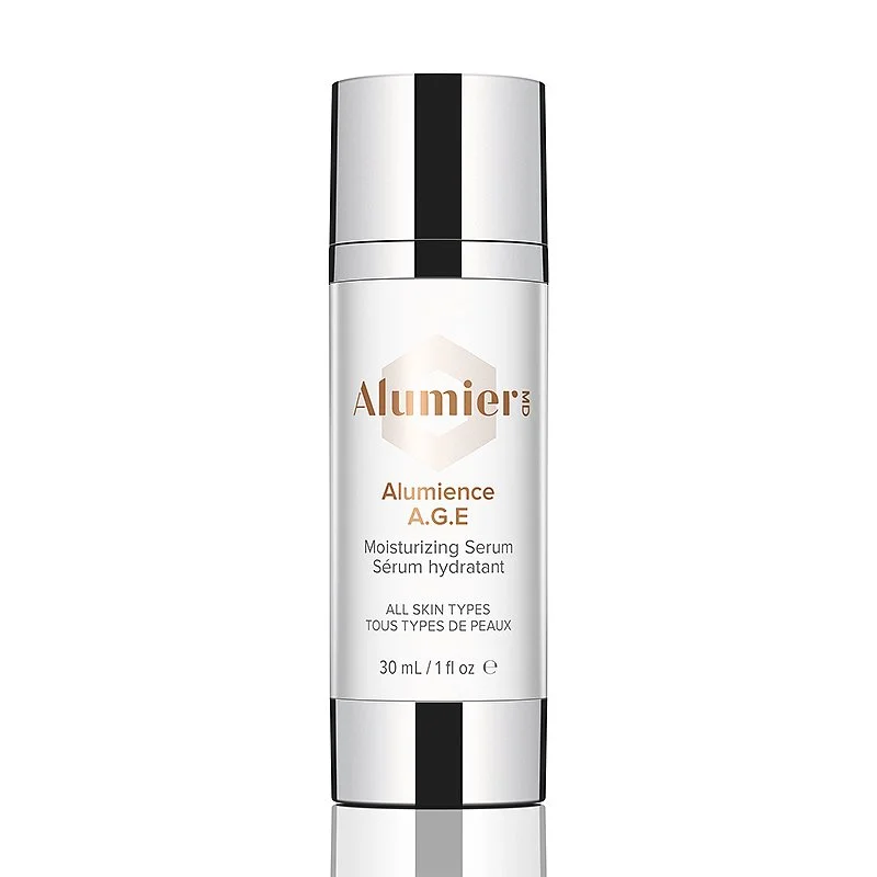 A white bottle of AlumierMD Alumience A.G.E moisturizing serum with a silver cap and black accents, designed for all skin types.