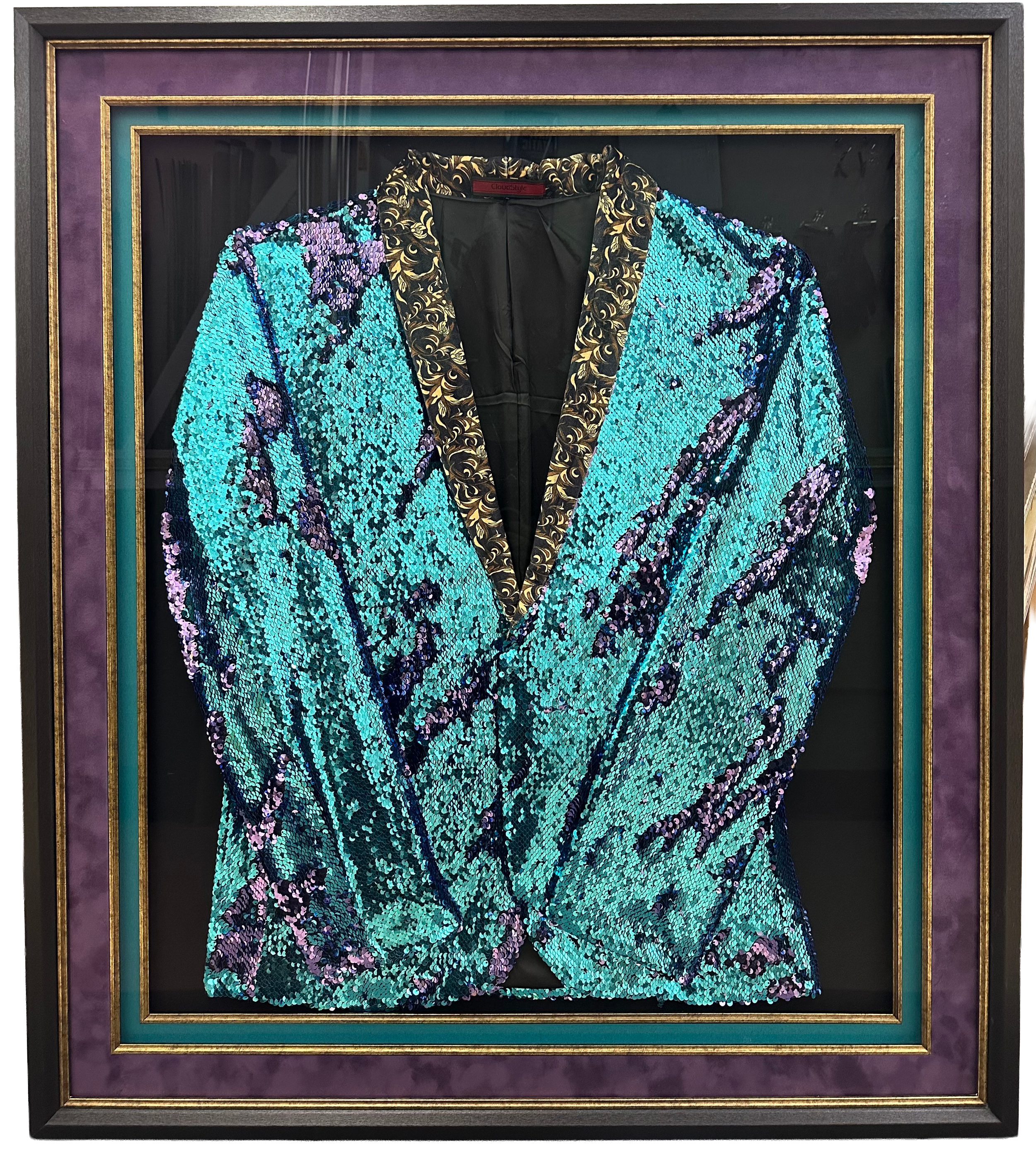 show jacket on a black linen backing with suede mats and fillets in a wood frame.