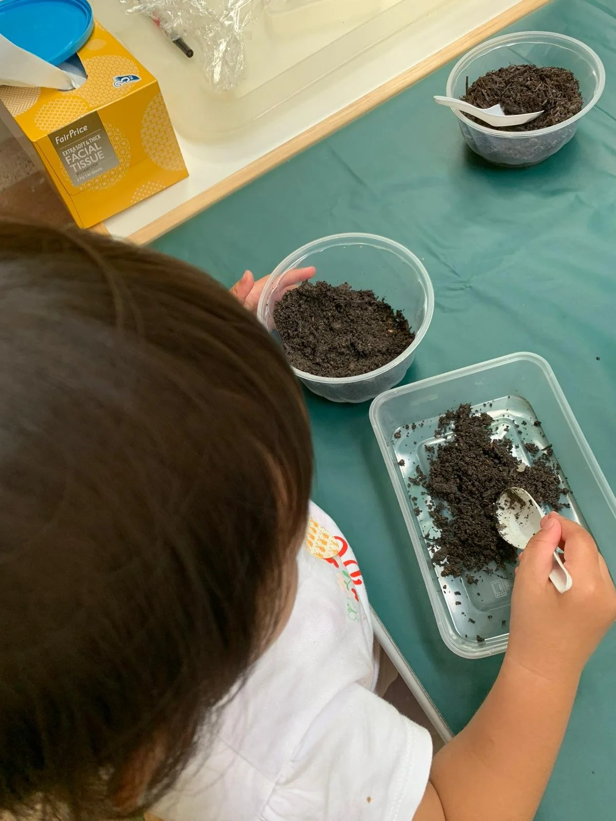 Emi scooping soil.jpeg