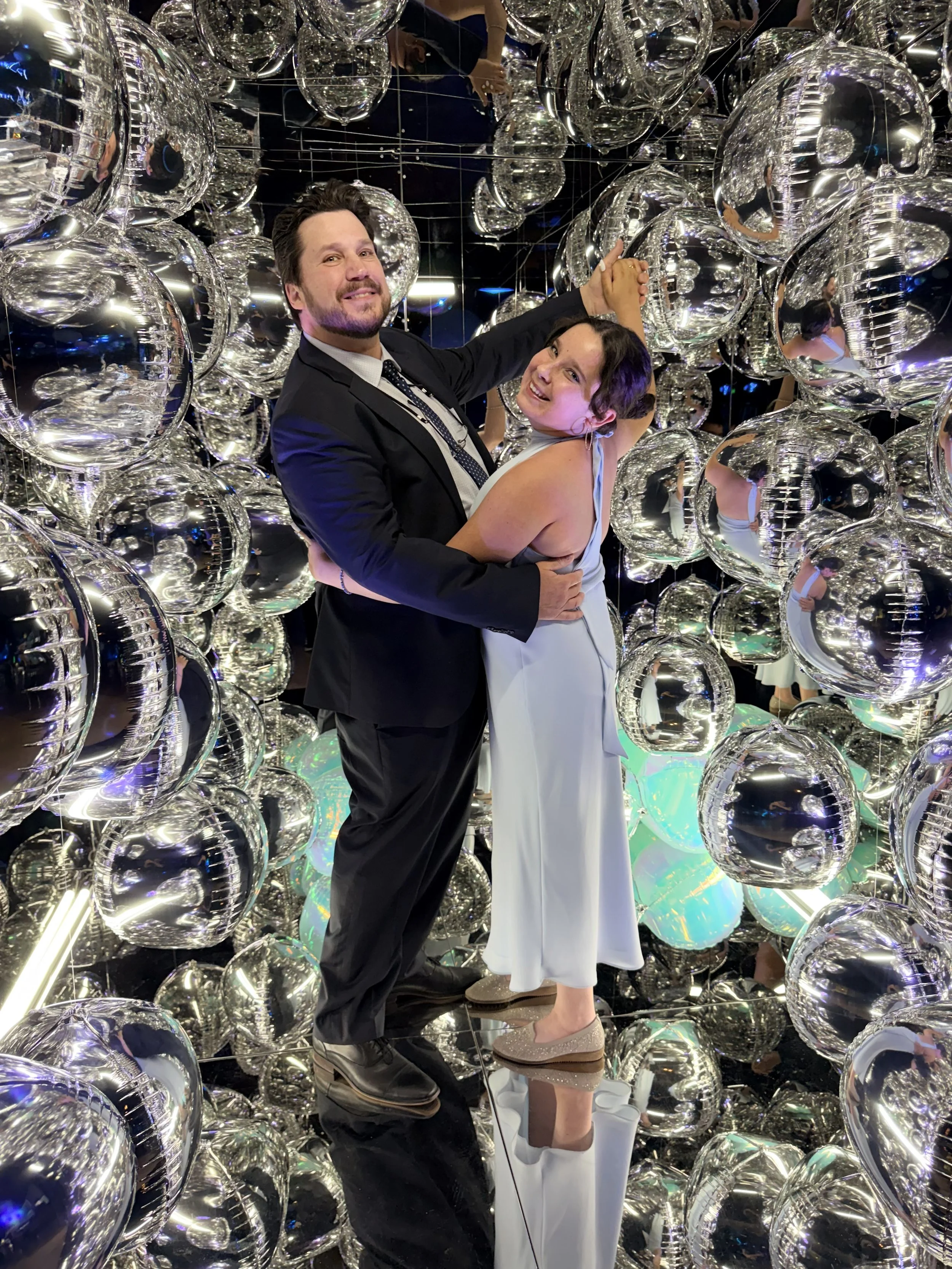 Father and daughter dancing inside the mirror cube photo booth at a bar-mitzvah