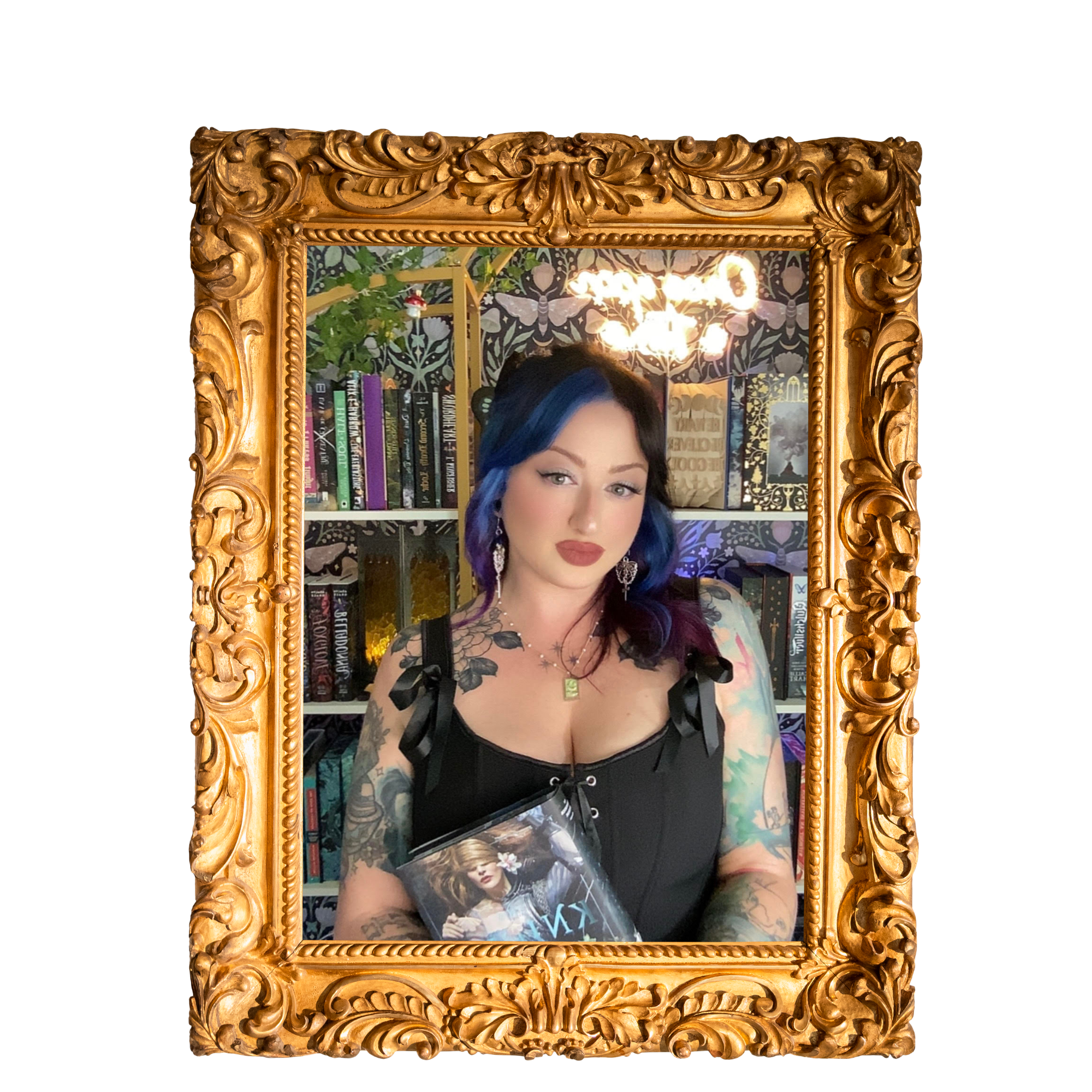 A woman with dark hair and tattoos on her arms is standing in front of a mirror with a gold ornate frame. She is holding a book and looking at her reflection. The background features a bookshelf, mural, and decorative lighting.
