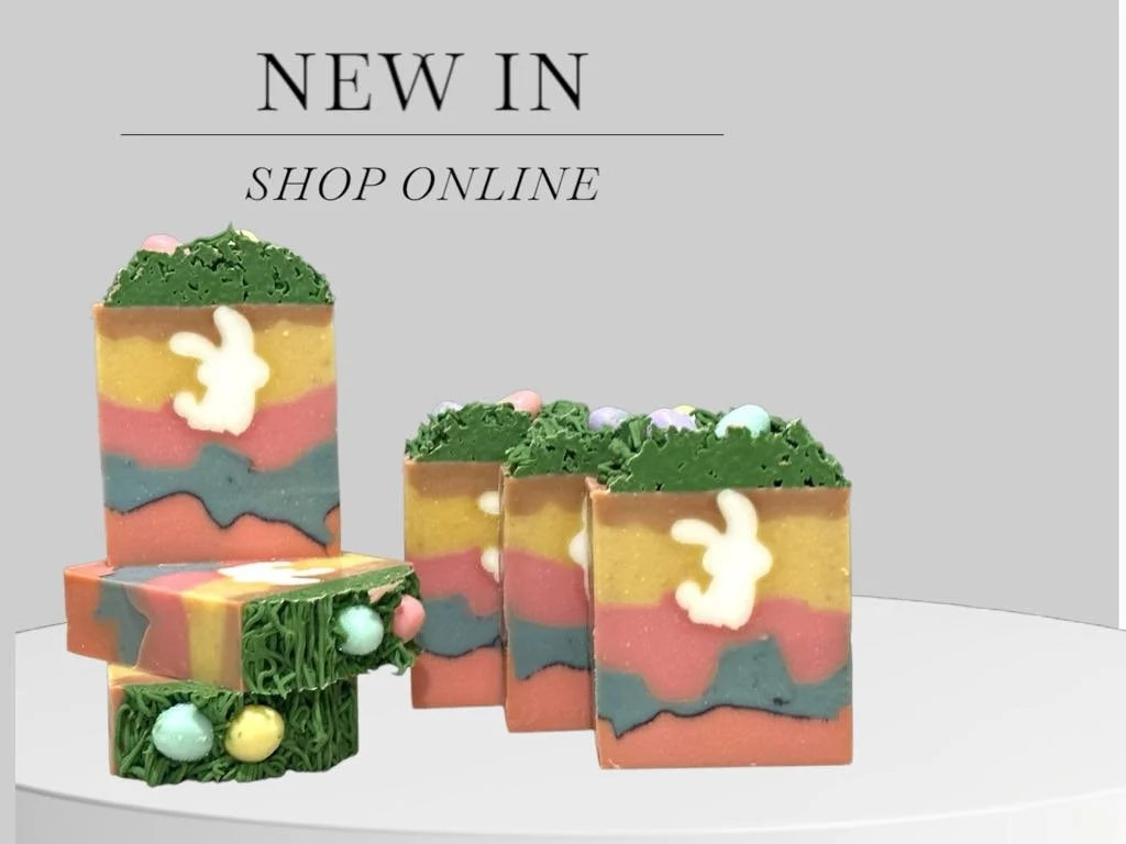 Several colorful soap bars with Easter bunny and egg designs, displayed on a white surface against a light gray background with the text 'New in Shop Online'.