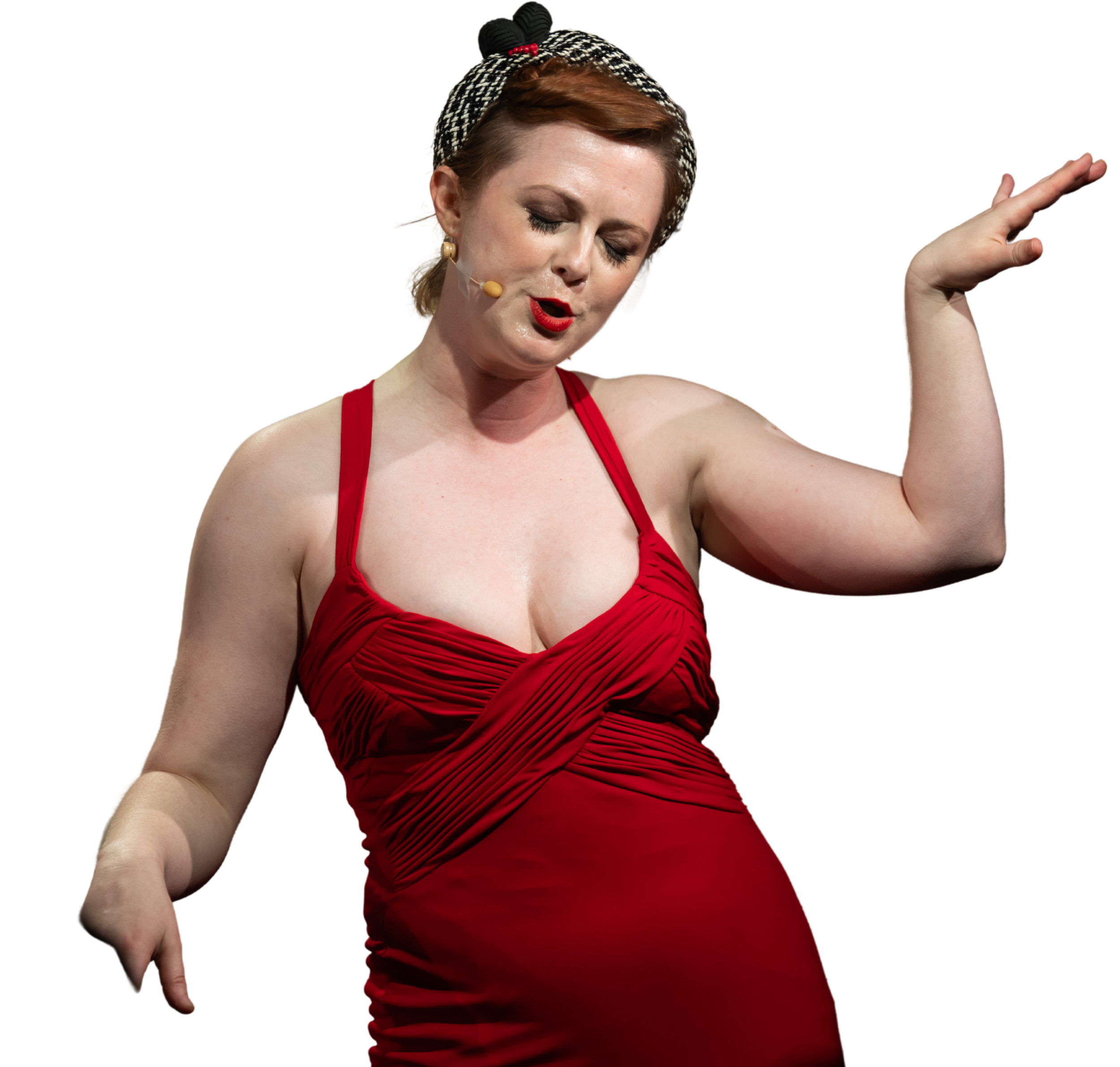 Woman in a red dress with her eyes closed and hand raised, wearing a black and white patterned headband.