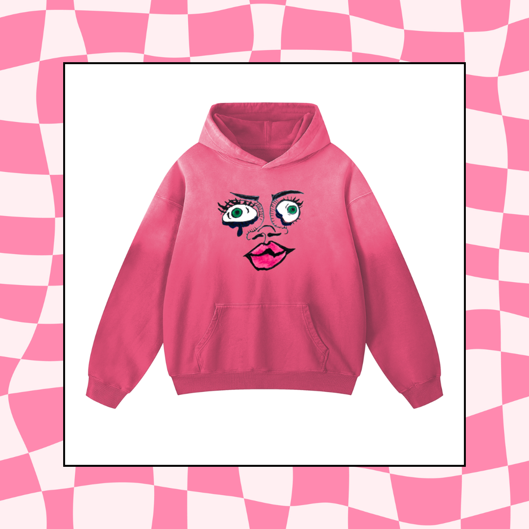 Pink hoodie with a face design that has large eyes, tears, and pink lips.
